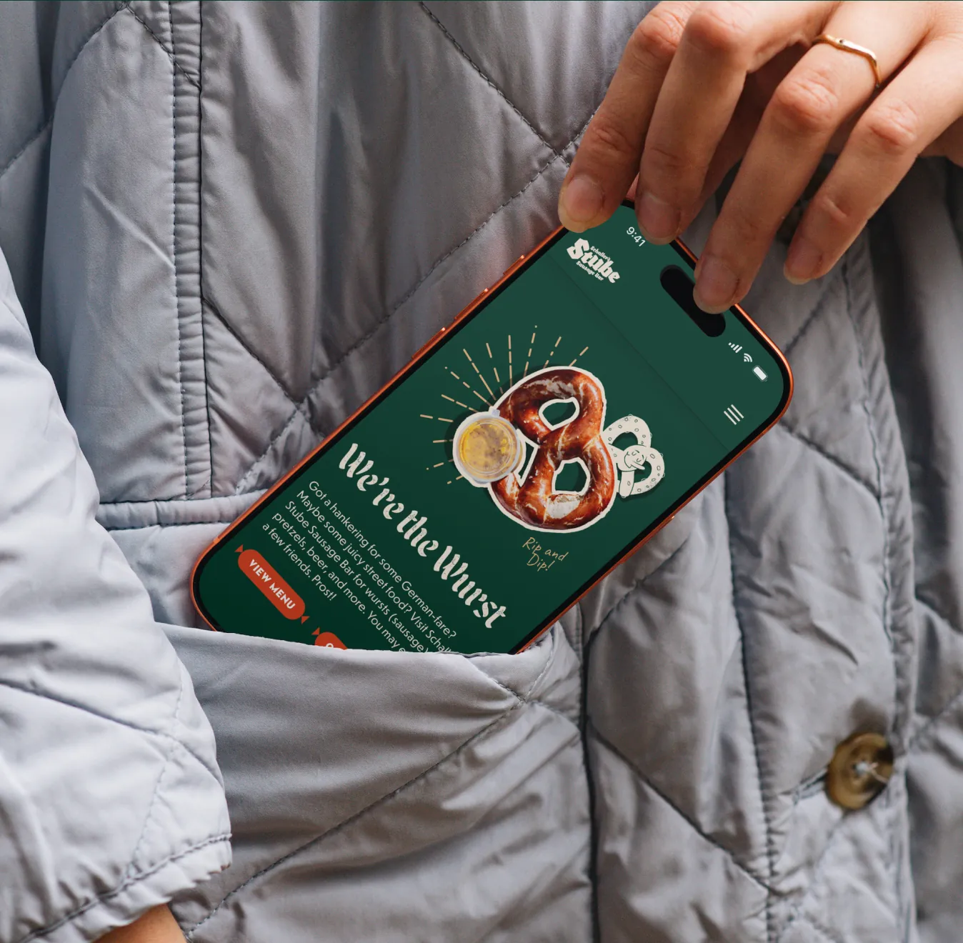 Phone in a jacket pocket showing the Schaller's Stube app