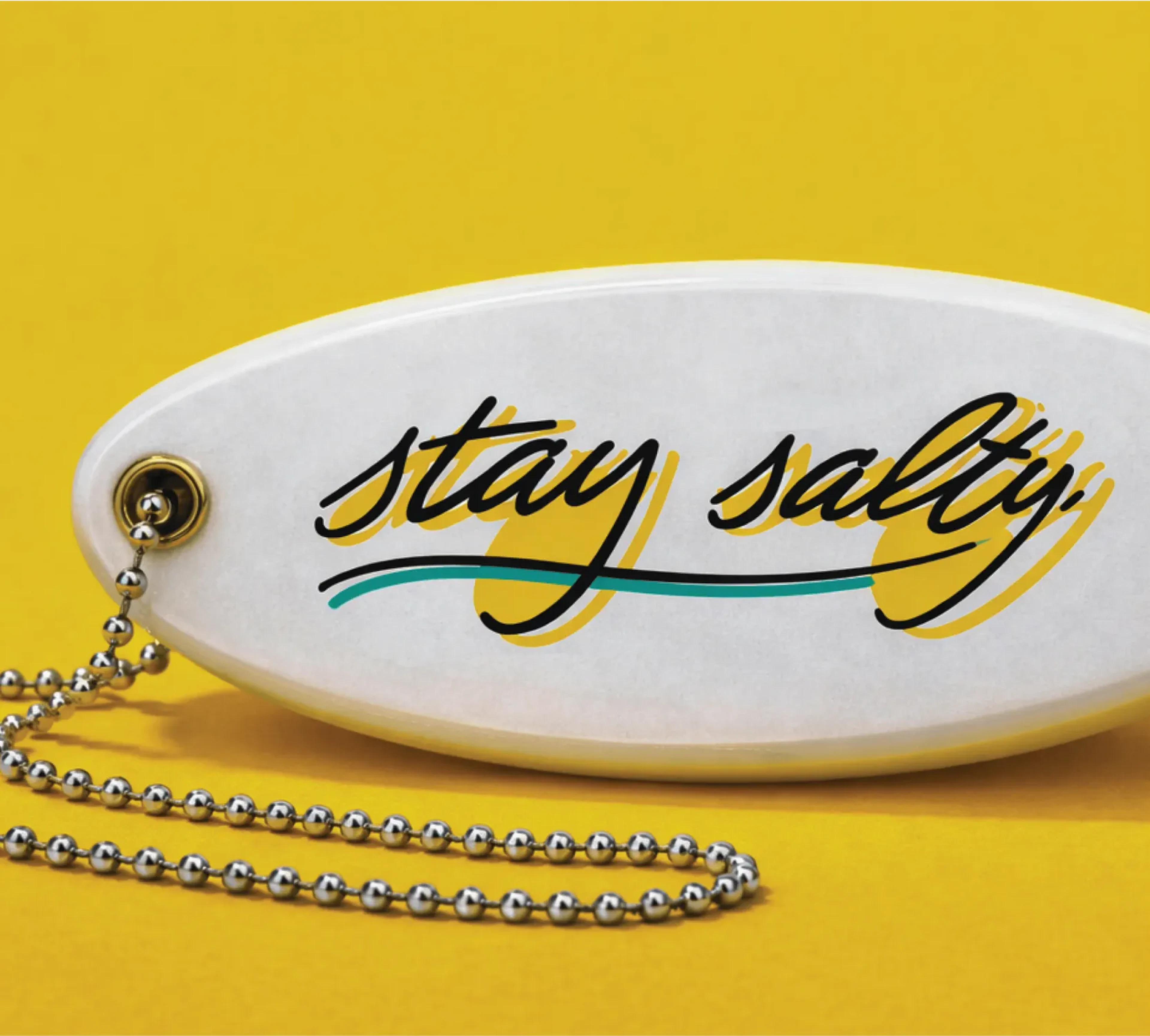 Surf Lodge key chain float with "Stay Salty" printed on it in a script font.