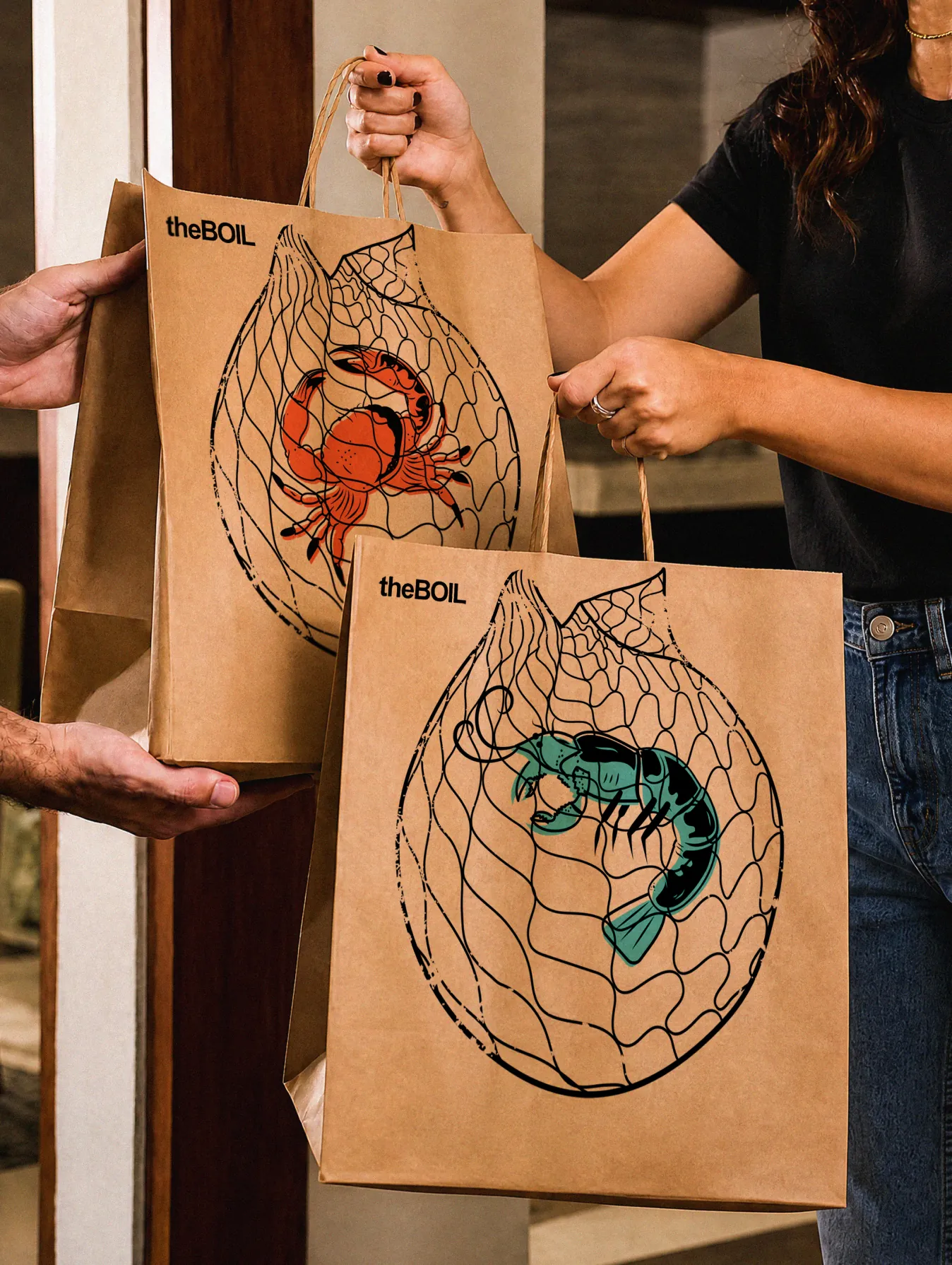 Person holding theBoil kraft paper takeout bags