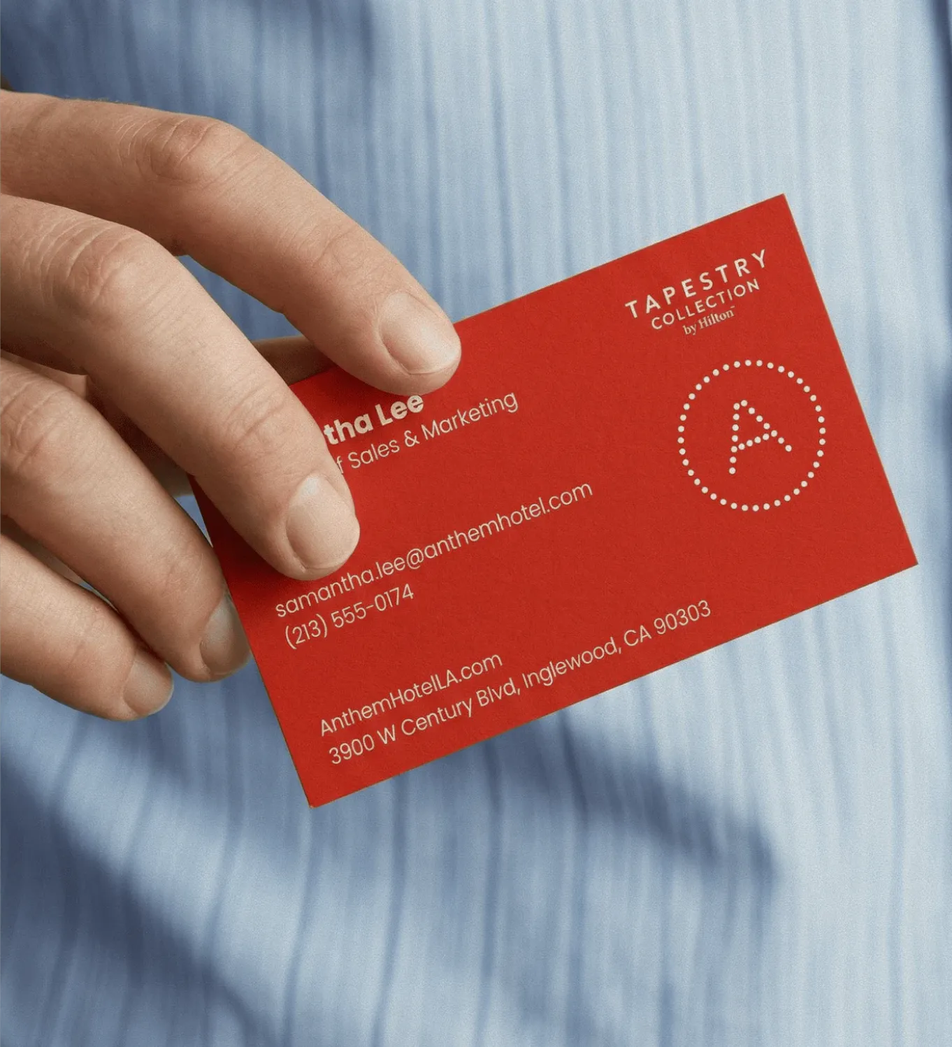 Image of a Anthem business card help gently by a pair of hands.