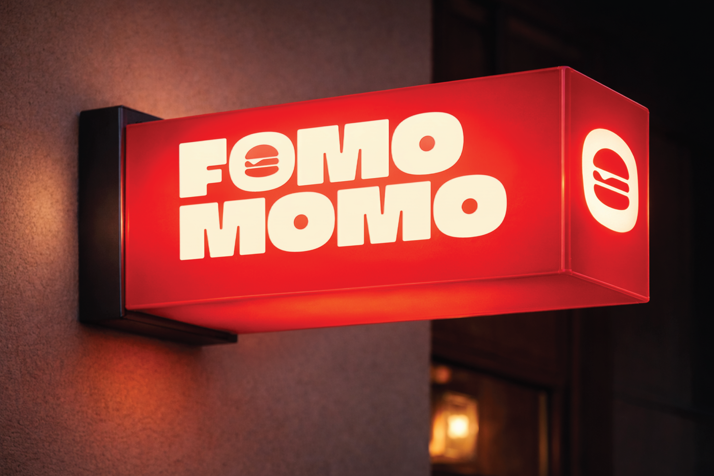 Lit up sign of burger restaurant Fomo Momo