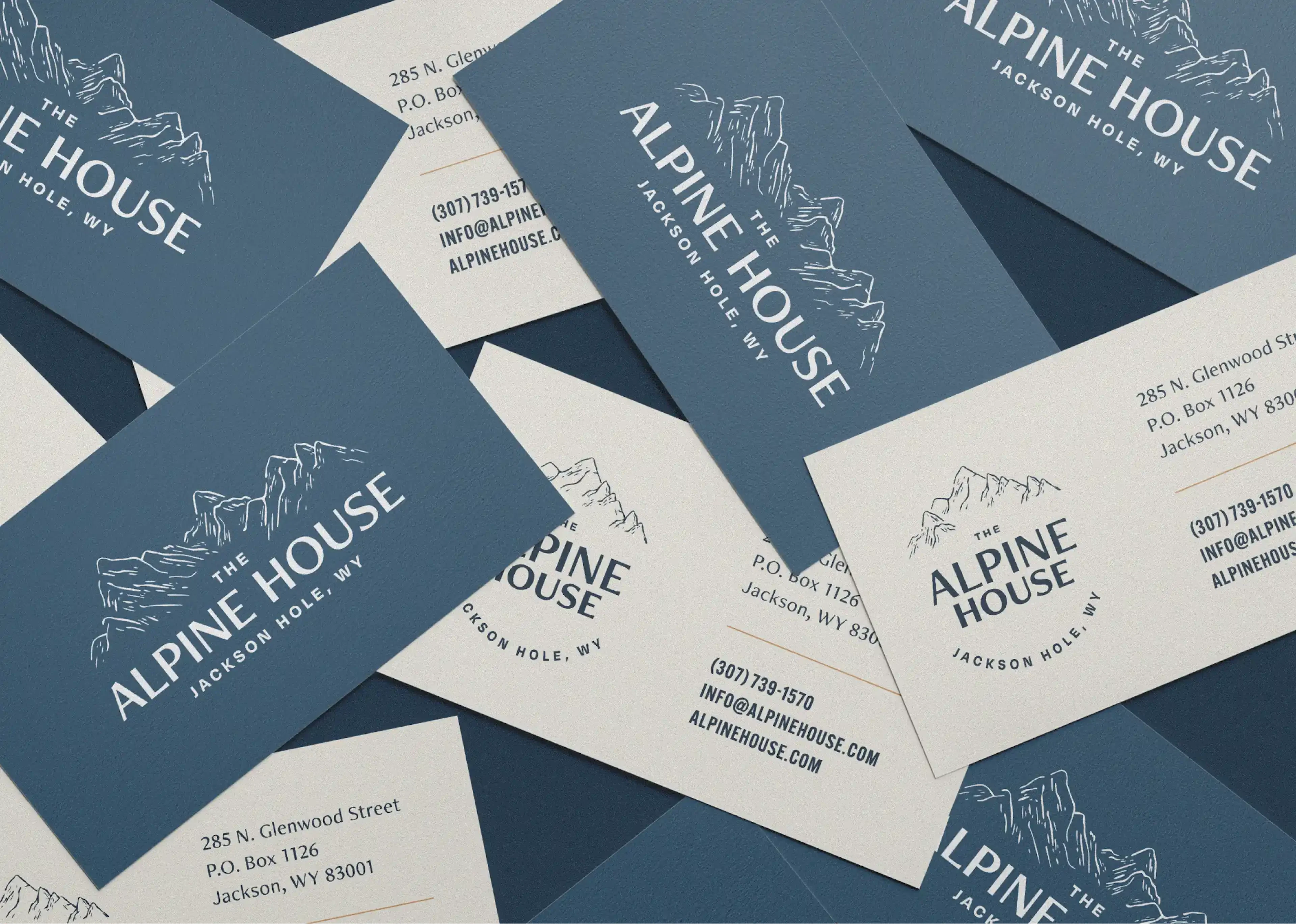 Scattered Alpine House business cards in navy and cream