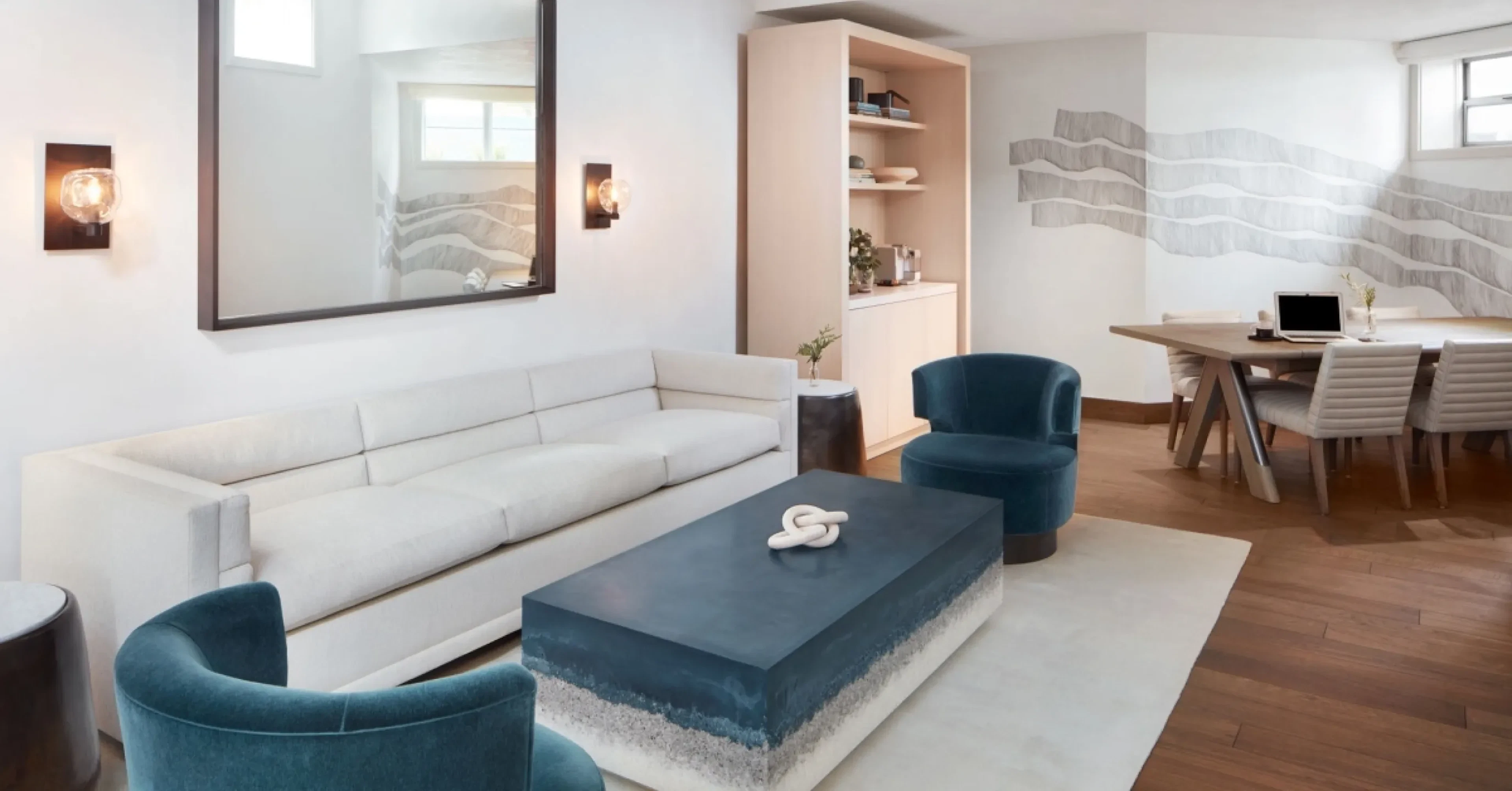 Living room with white sofa and teal armchairs