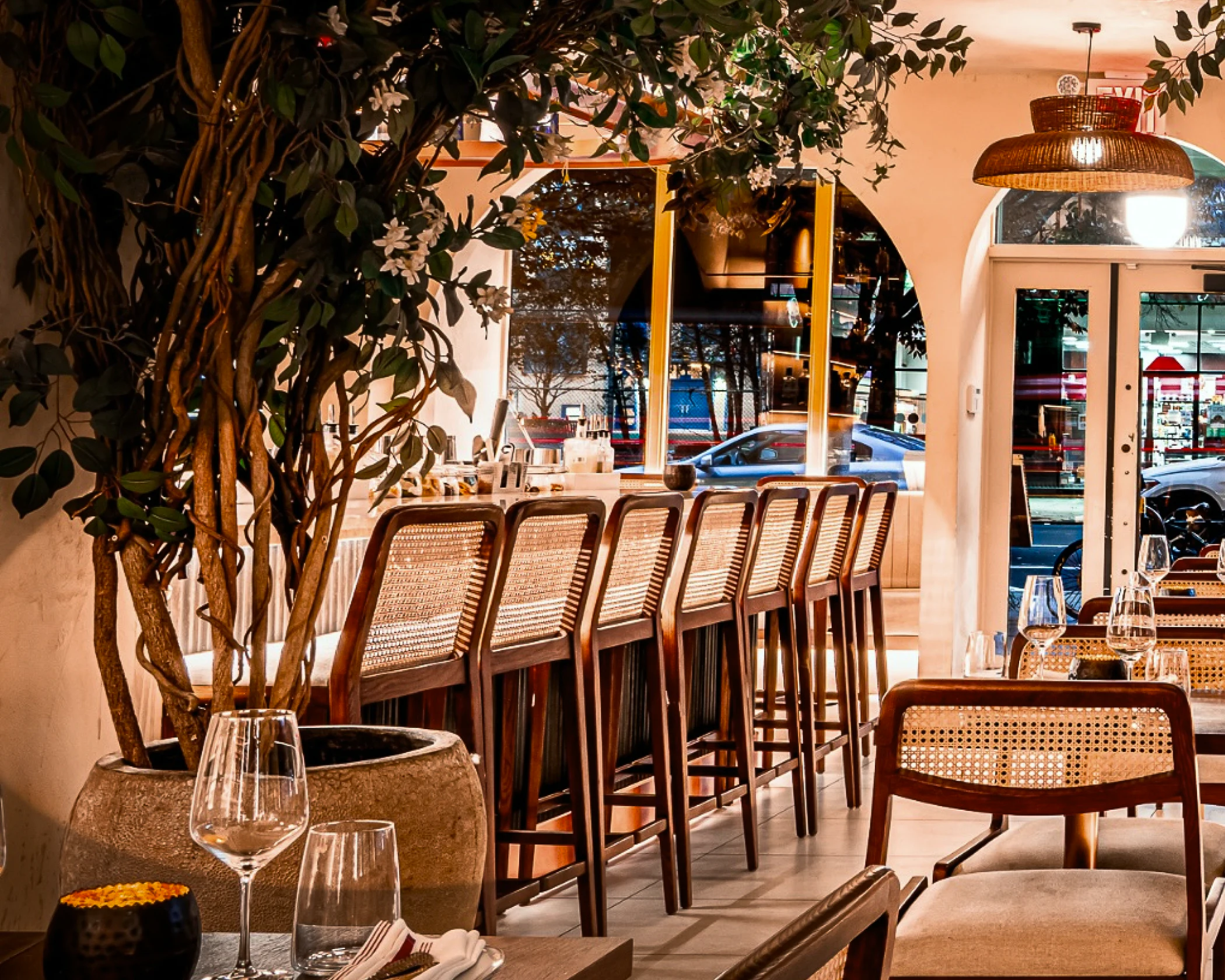 Bar chairs aligned in a brightly lit restaurant