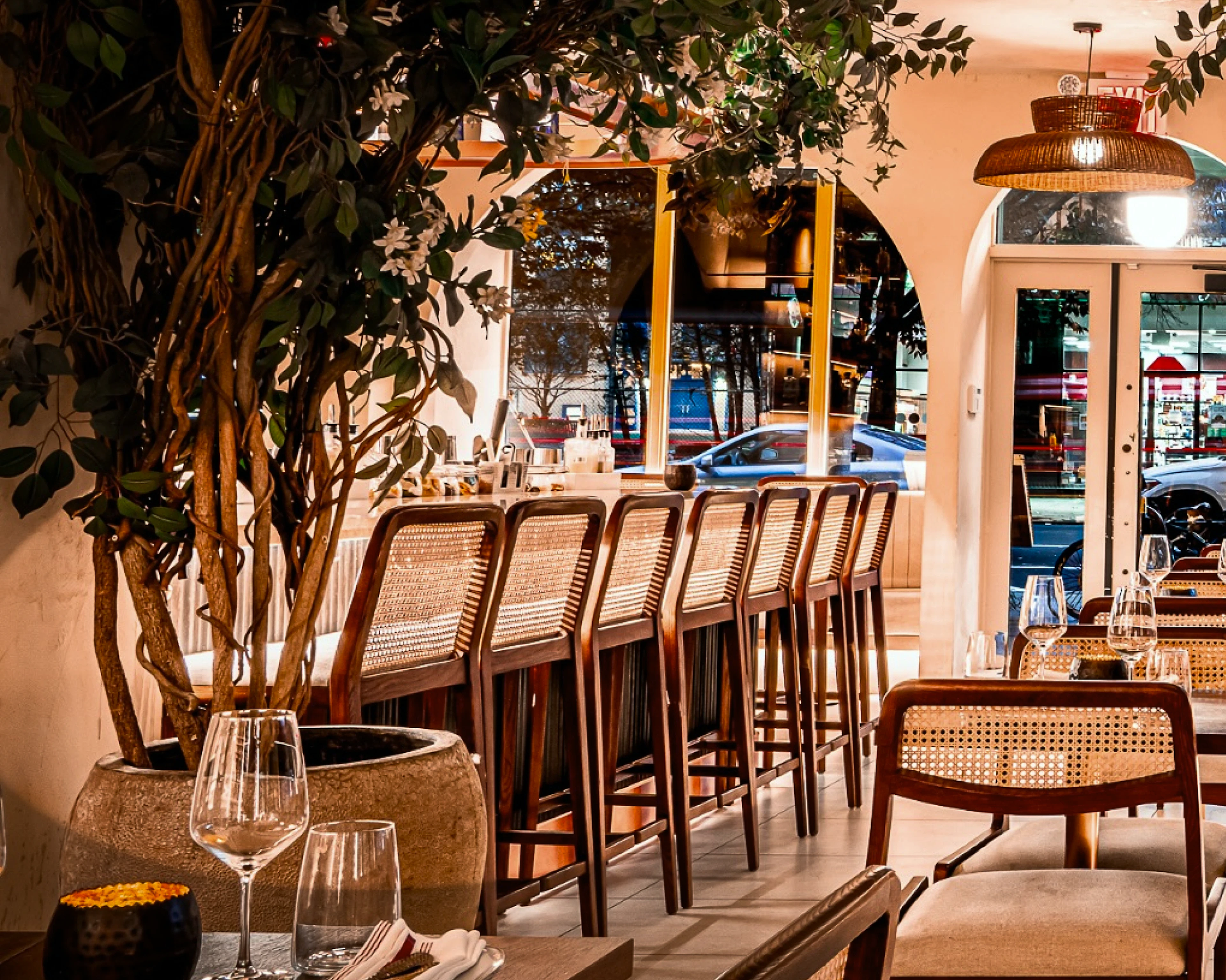 Bar chairs aligned in a brightly lit restaurant