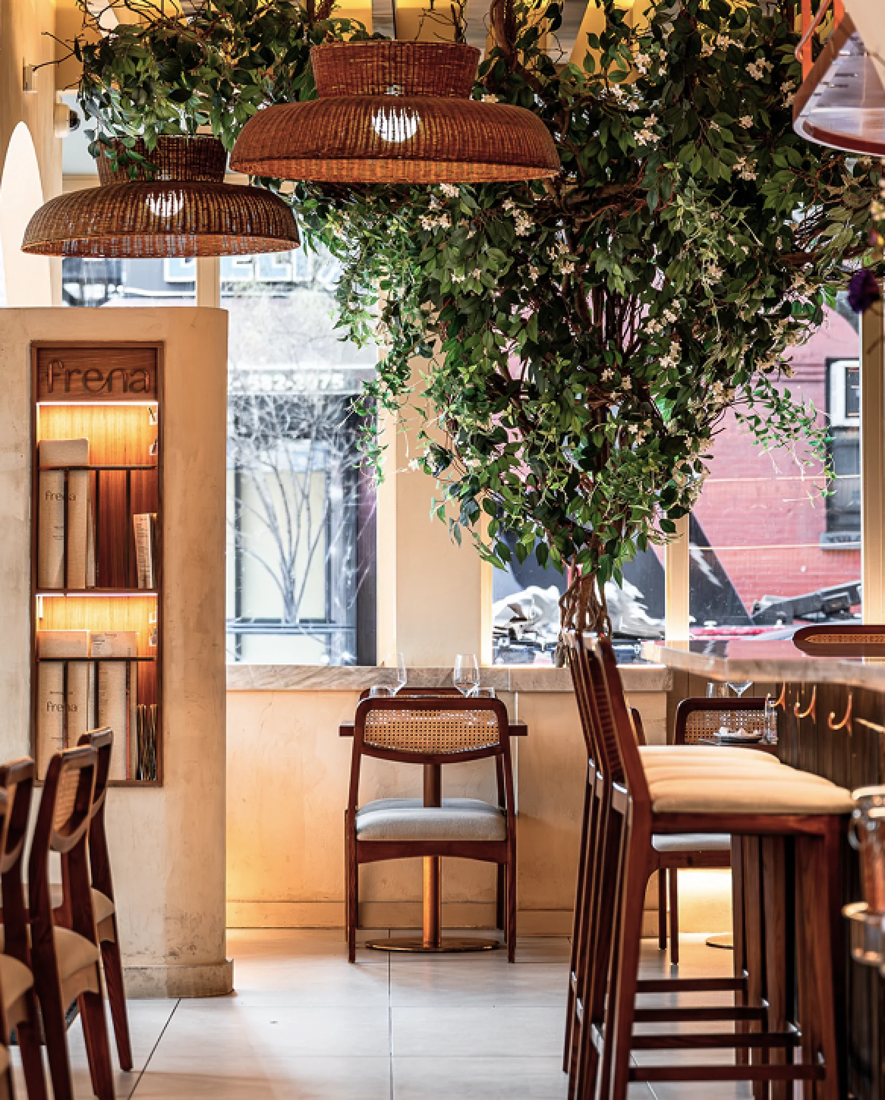 Frena restaurant interior with rattan pendant lights and greenery