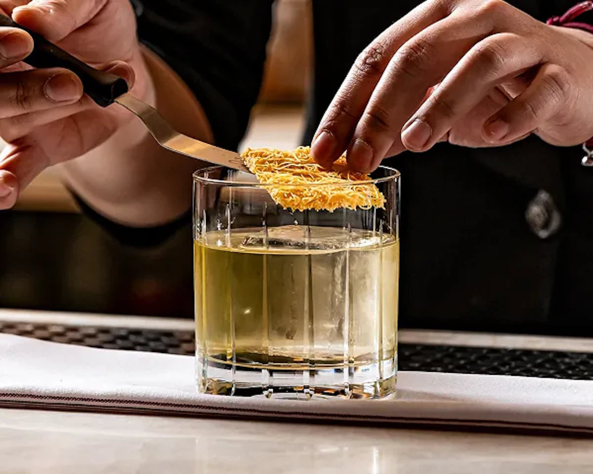 Person finessing a cocktail