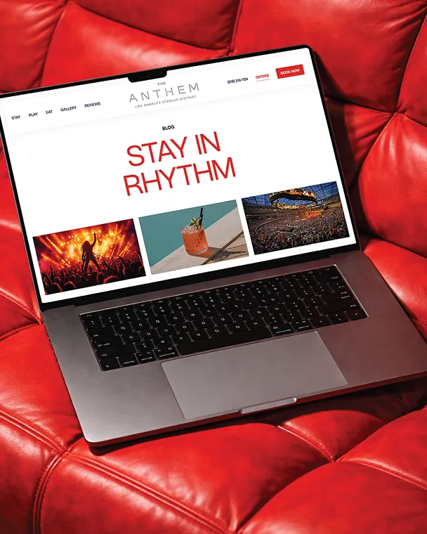Laptop on red leather couch