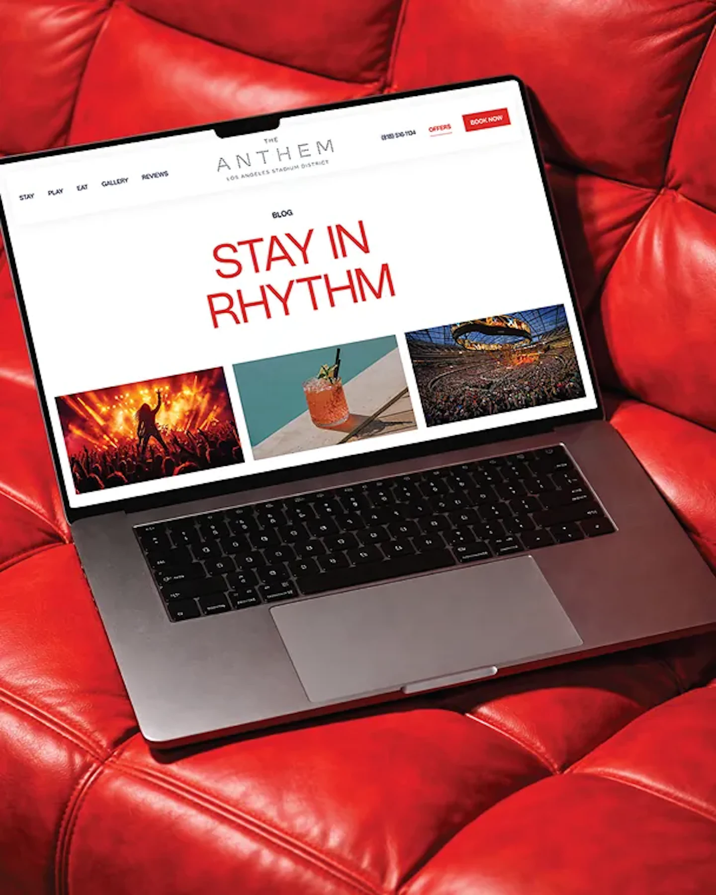 Laptop on red leather couch