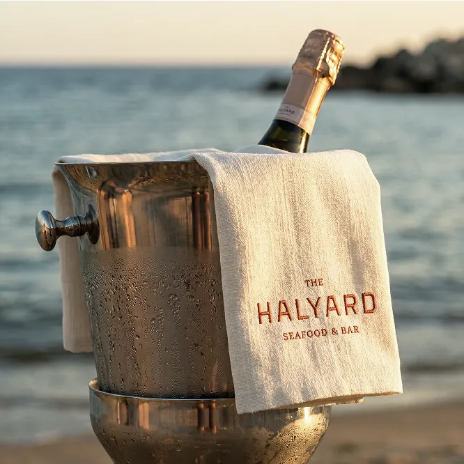 Champagne bottle by the ocean