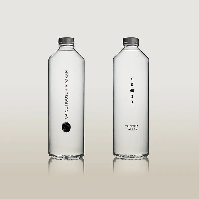 Two water bottles against a solid clay background