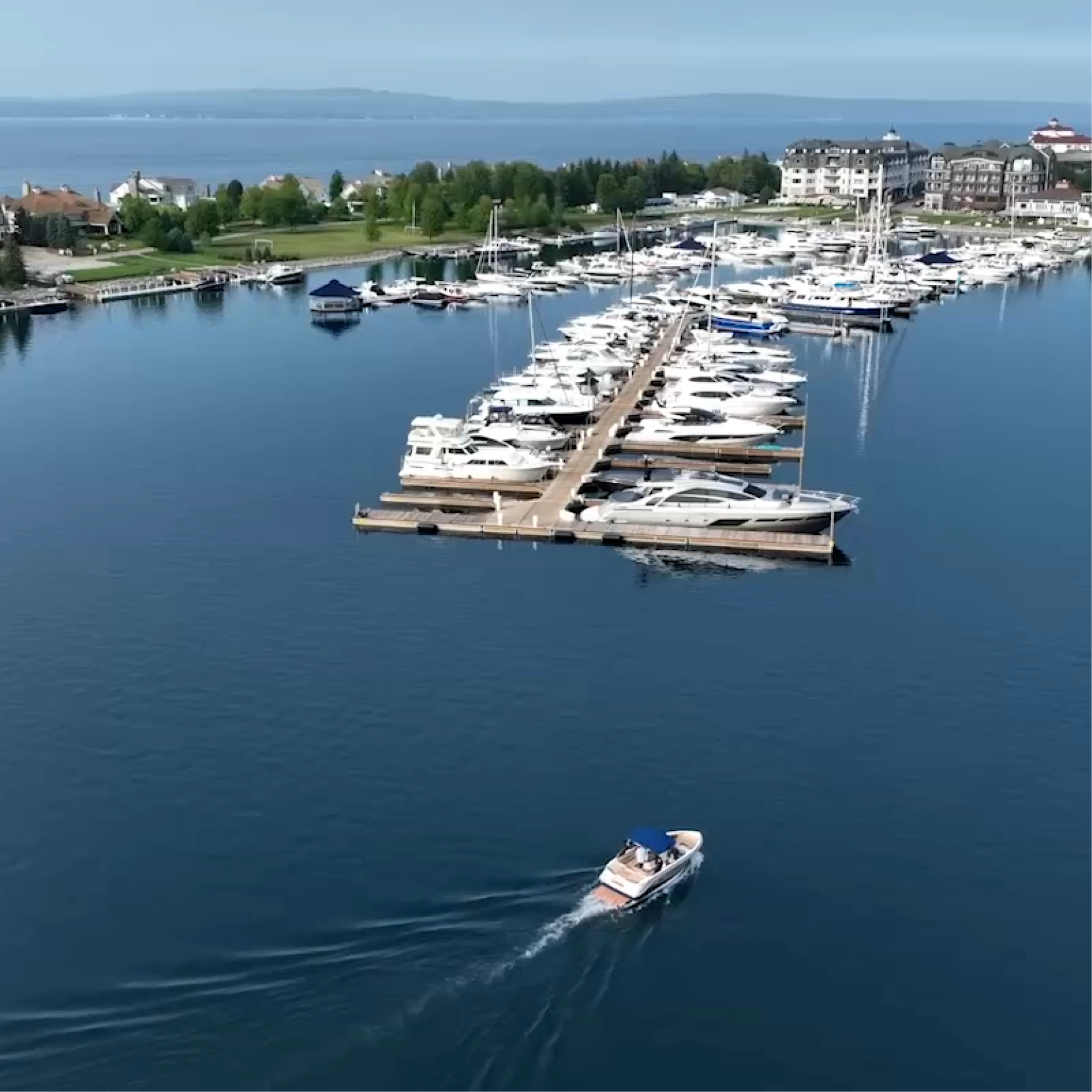 Aerial view of Grove Point Marinas with a boat leaving the docks