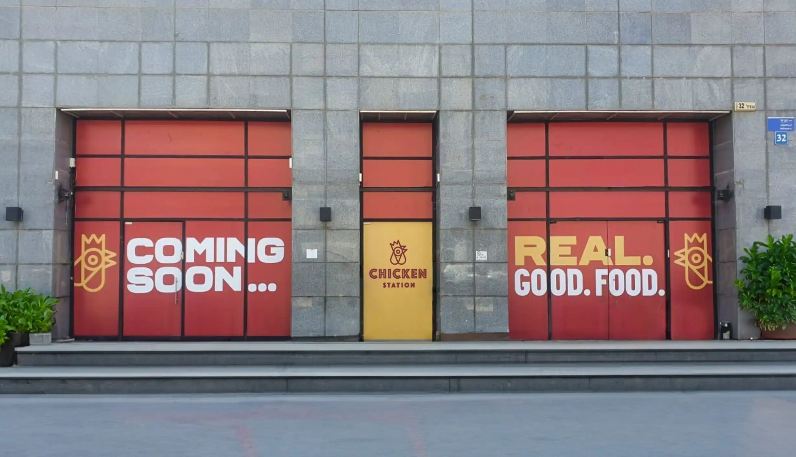 Chicken Station storefront exterior with red 'Coming Soon' shutters