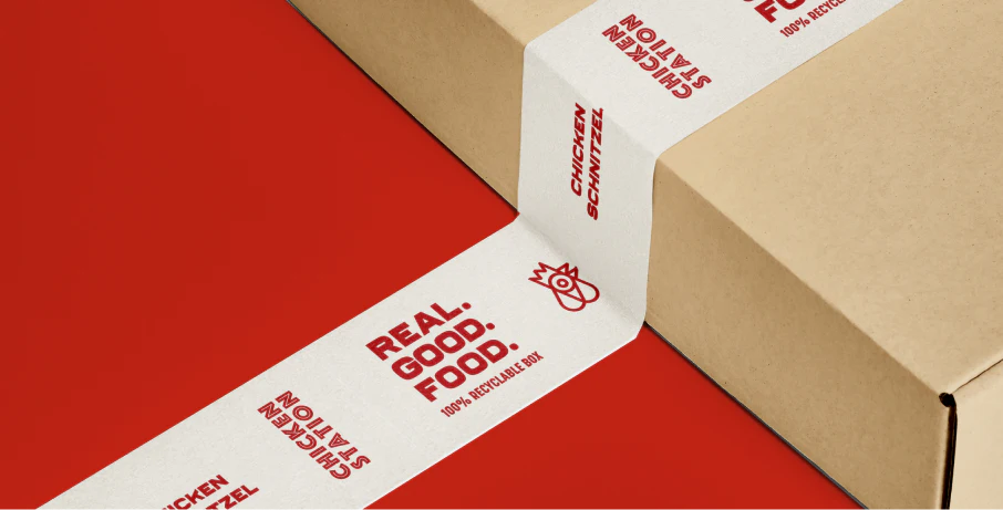 Cardboard box packaging design for Chicken station that also depicts white washi tape with branded Chicken Station elements like their tagline and logo in red