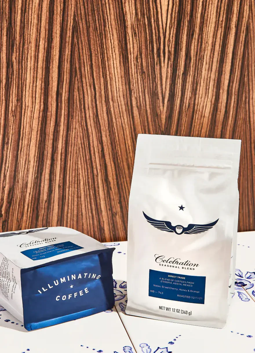 Intelligentsia coffee bags on a tiled counter against a wood-grain wall