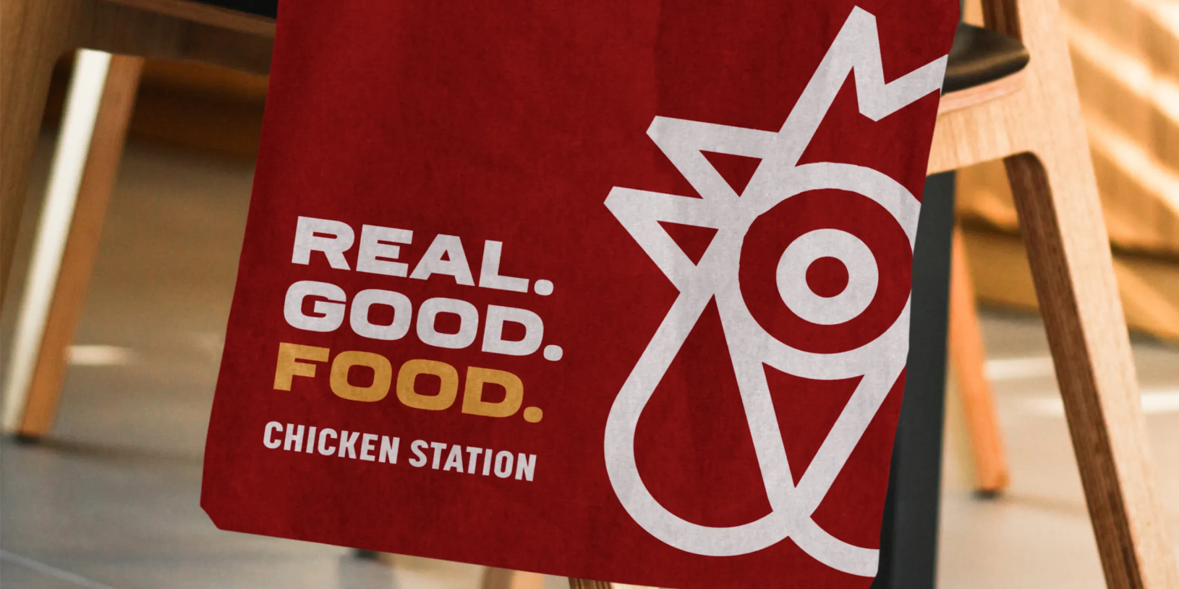 Tote bag with "REAL. GOOD. FOOD." and the Chicken Station logo on it.