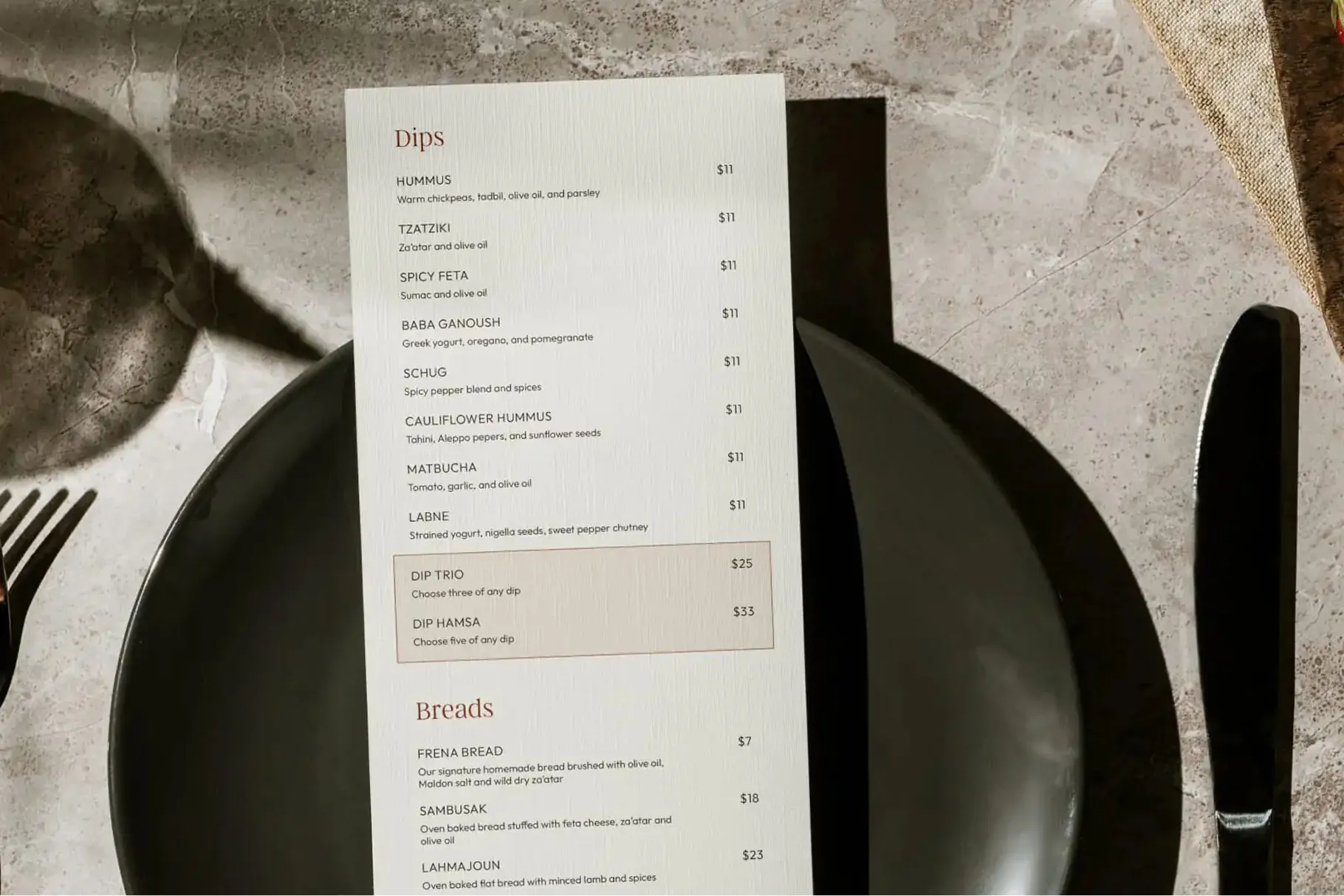 Frena dips menu on a table setting with black plates