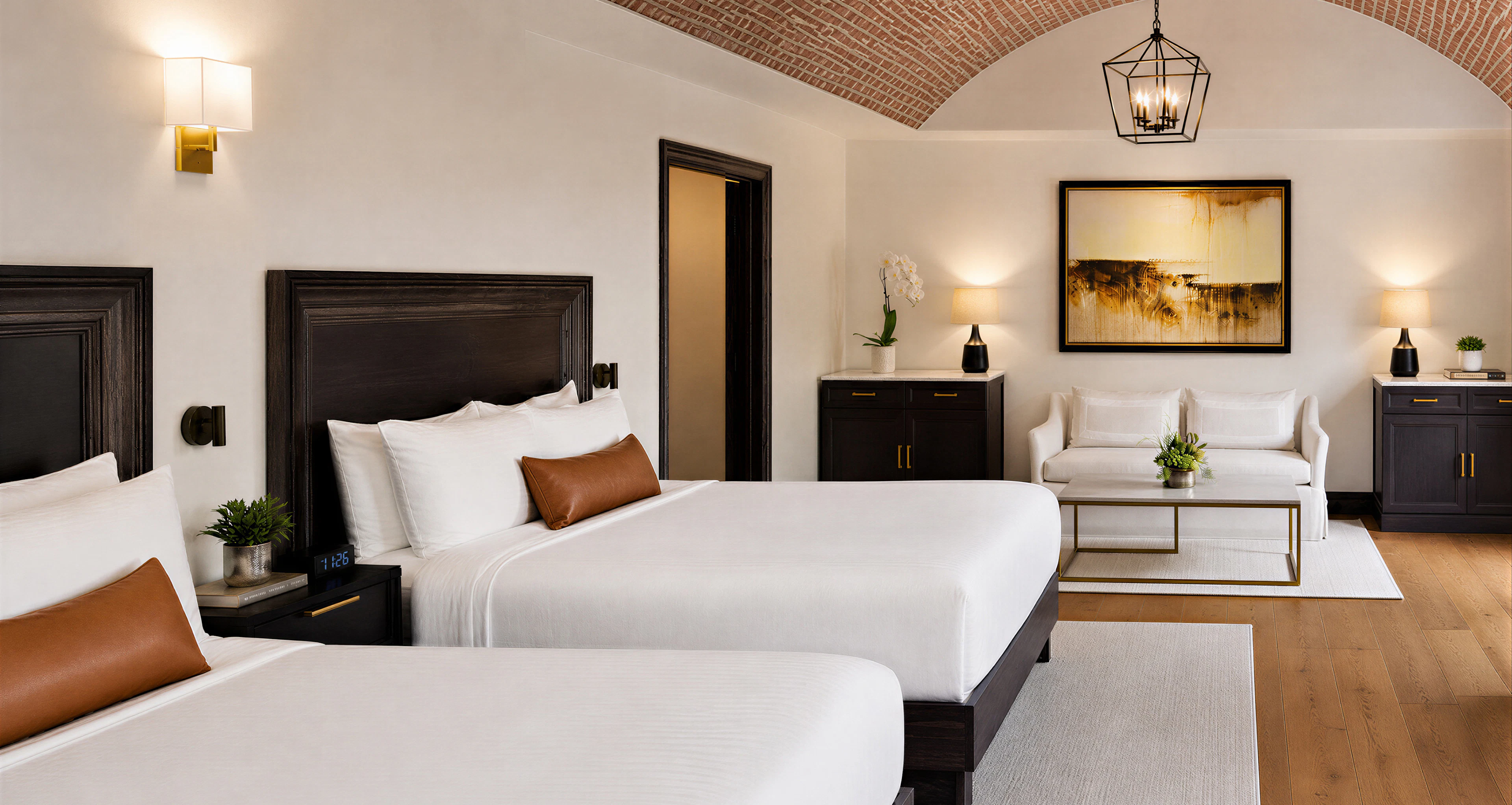 Hotel room with bed, seating area, and brick ceiling