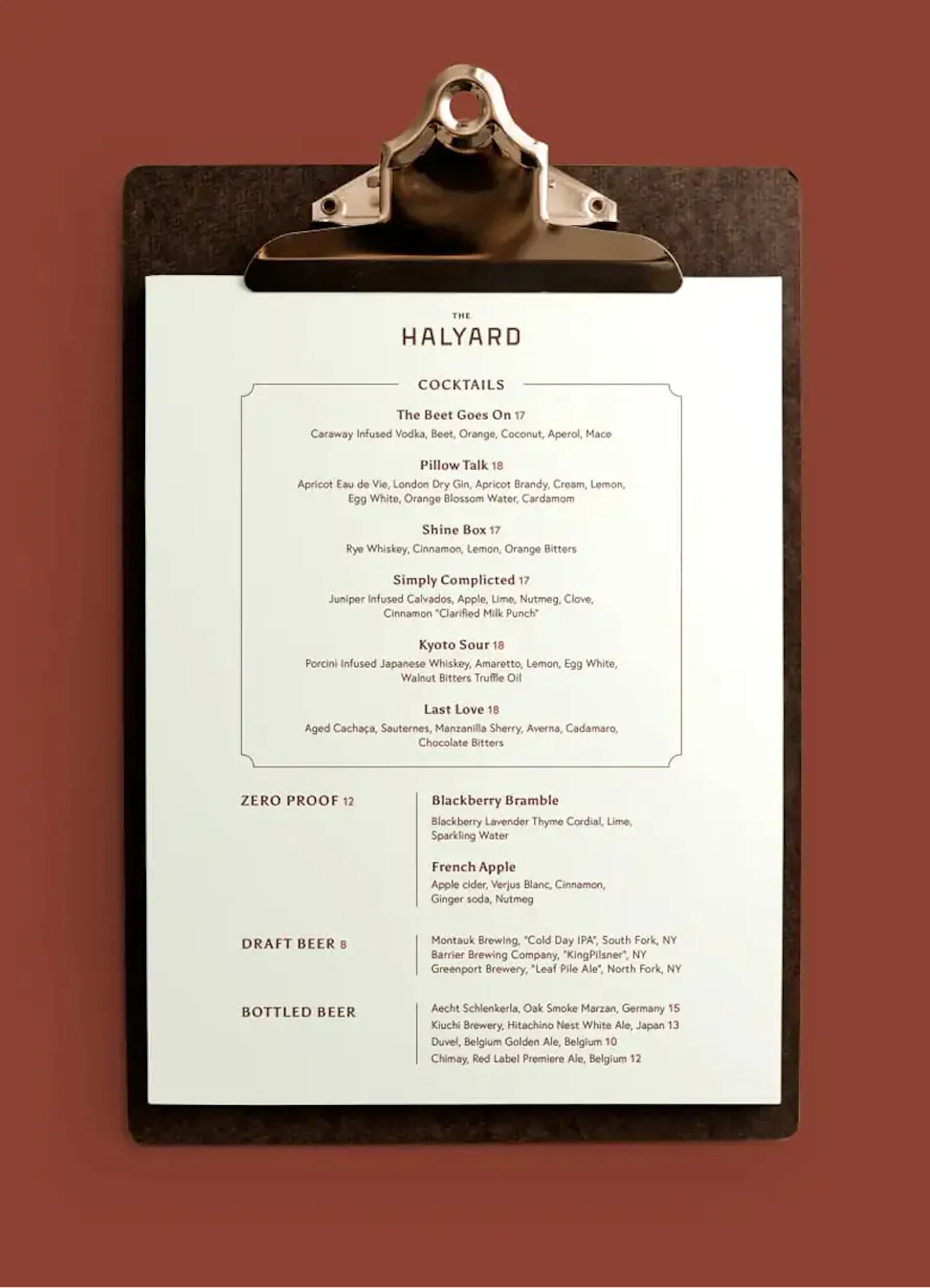 The Halyard cocktail menu clipped to a dark clipboard
