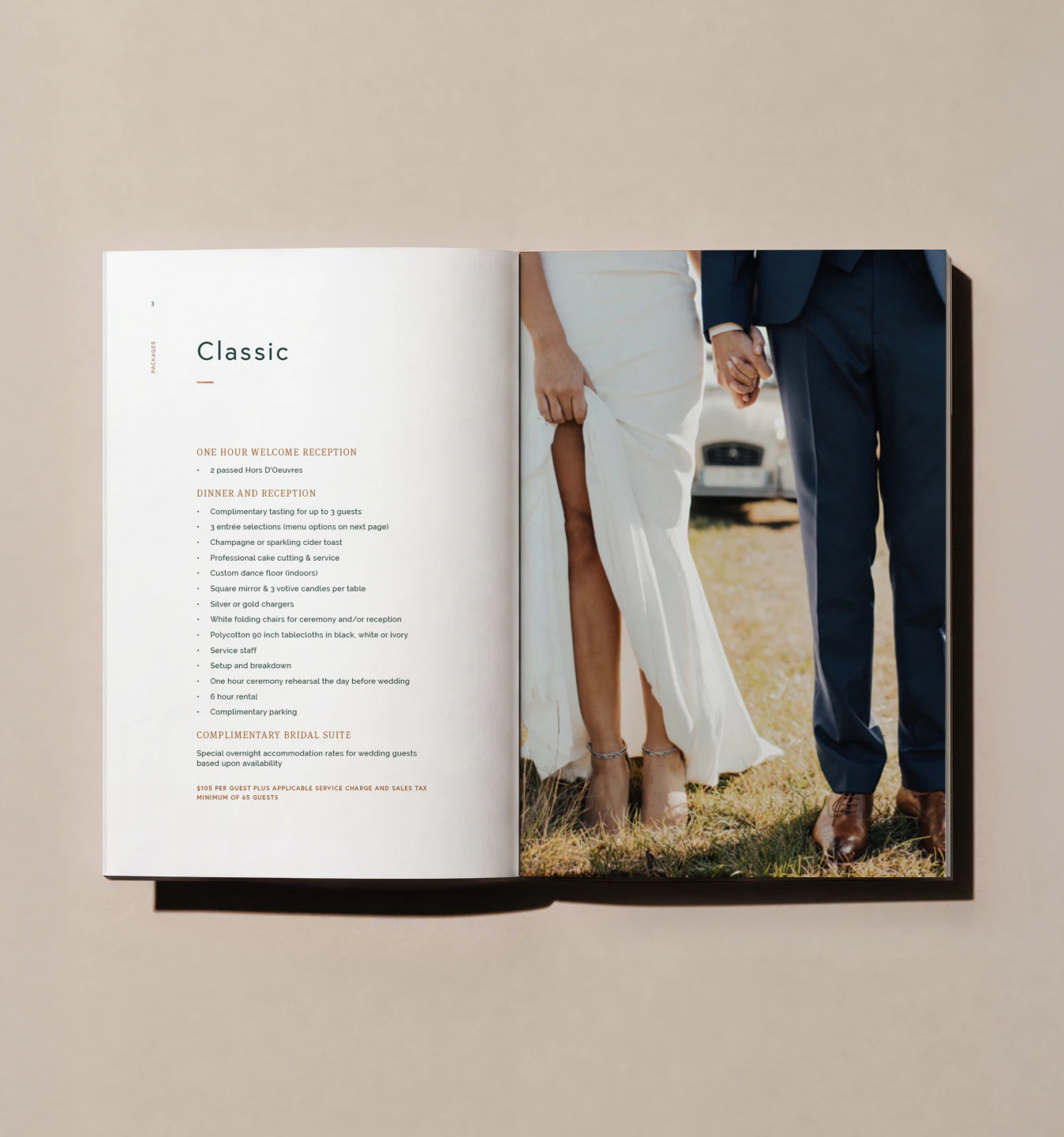 Open booklet spread with wedding text beside couple's legs on grass