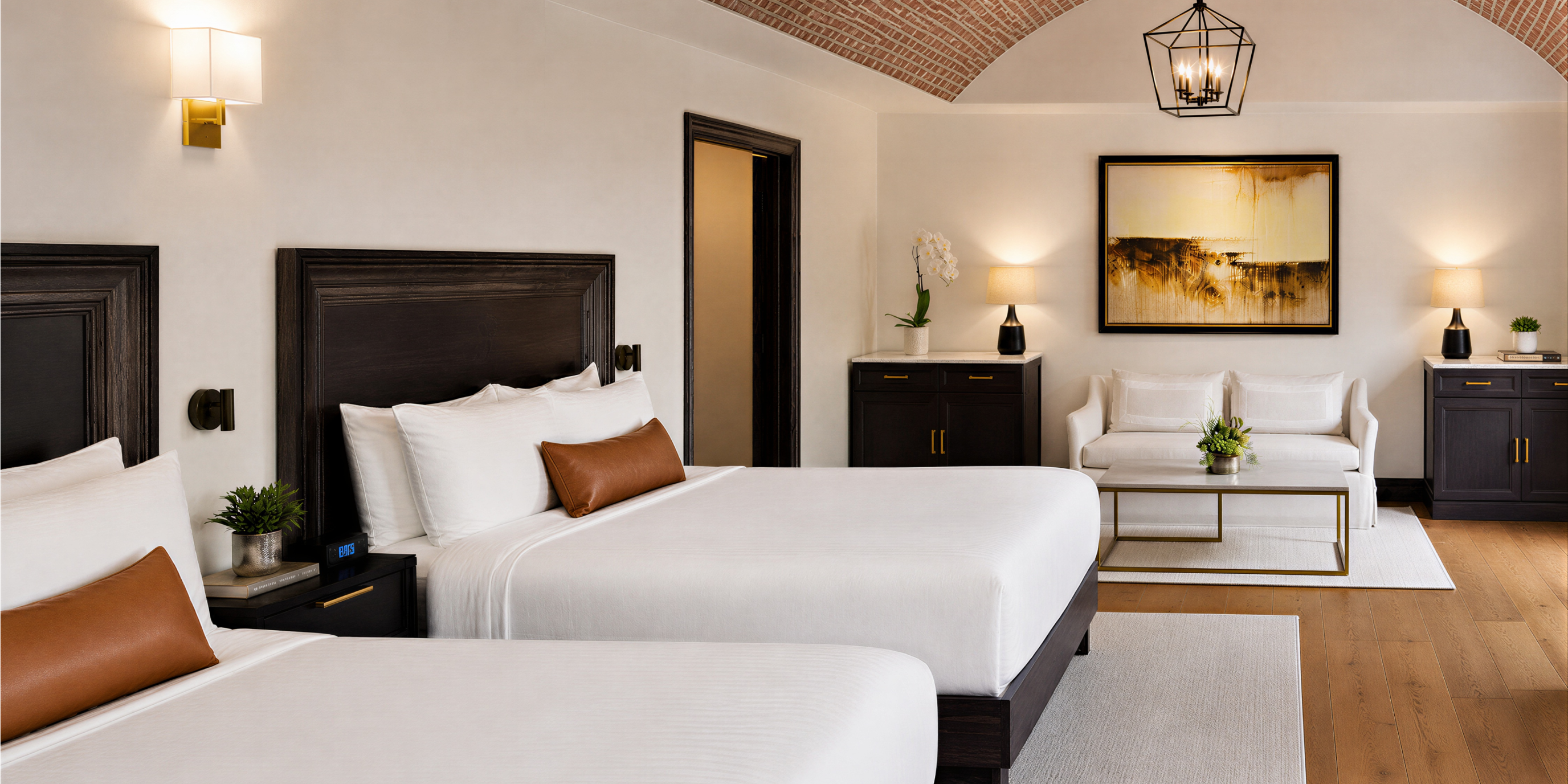 Hotel room with bed, seating area, and brick ceiling
