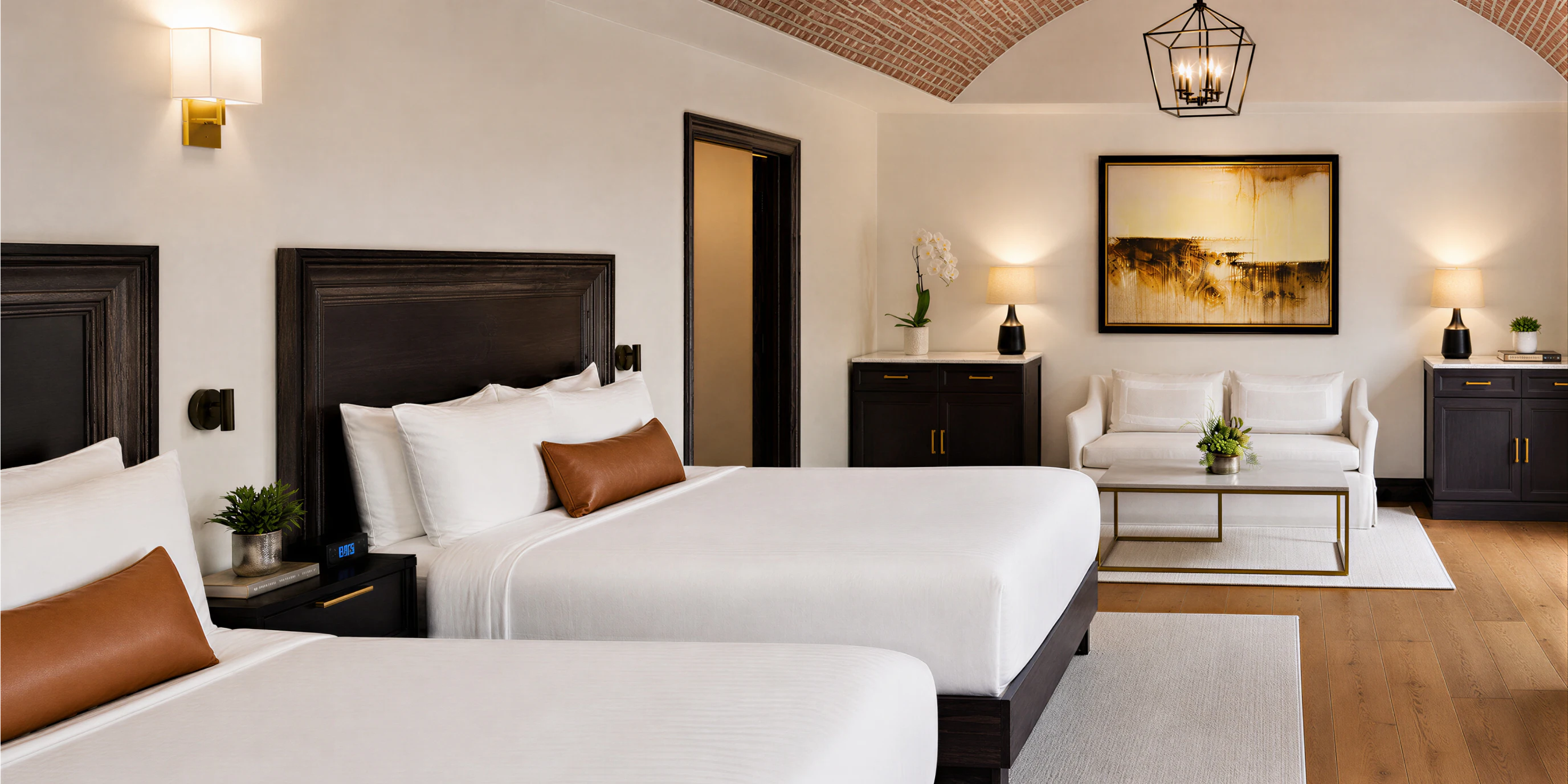 Hotel room with bed, seating area, and brick ceiling