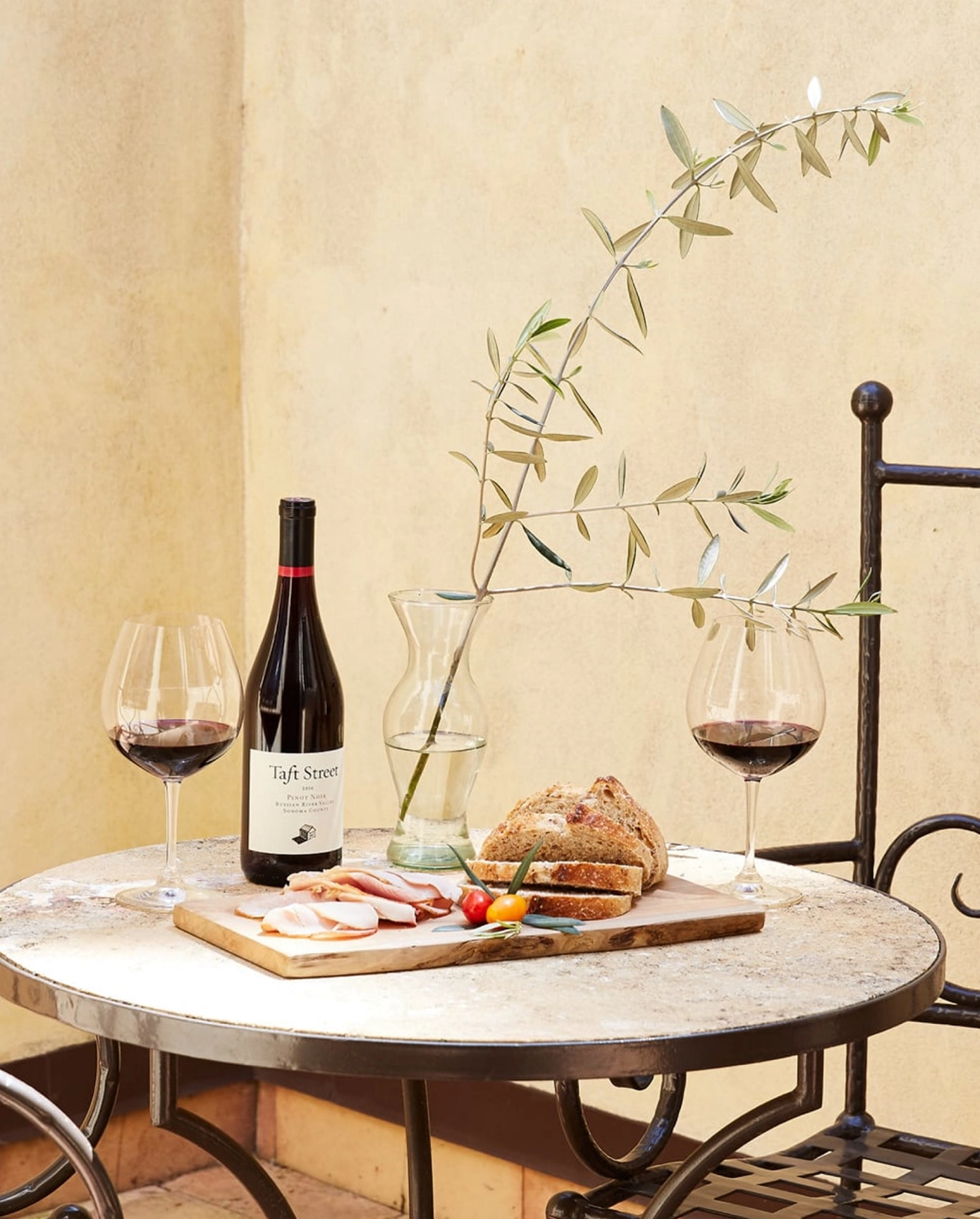 Wine, bread and charcuterie on outdoor table