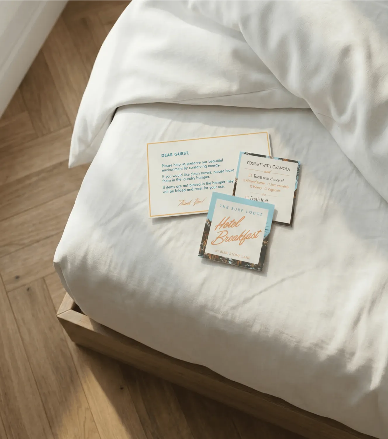 Surf Lodge print materials on a bed.