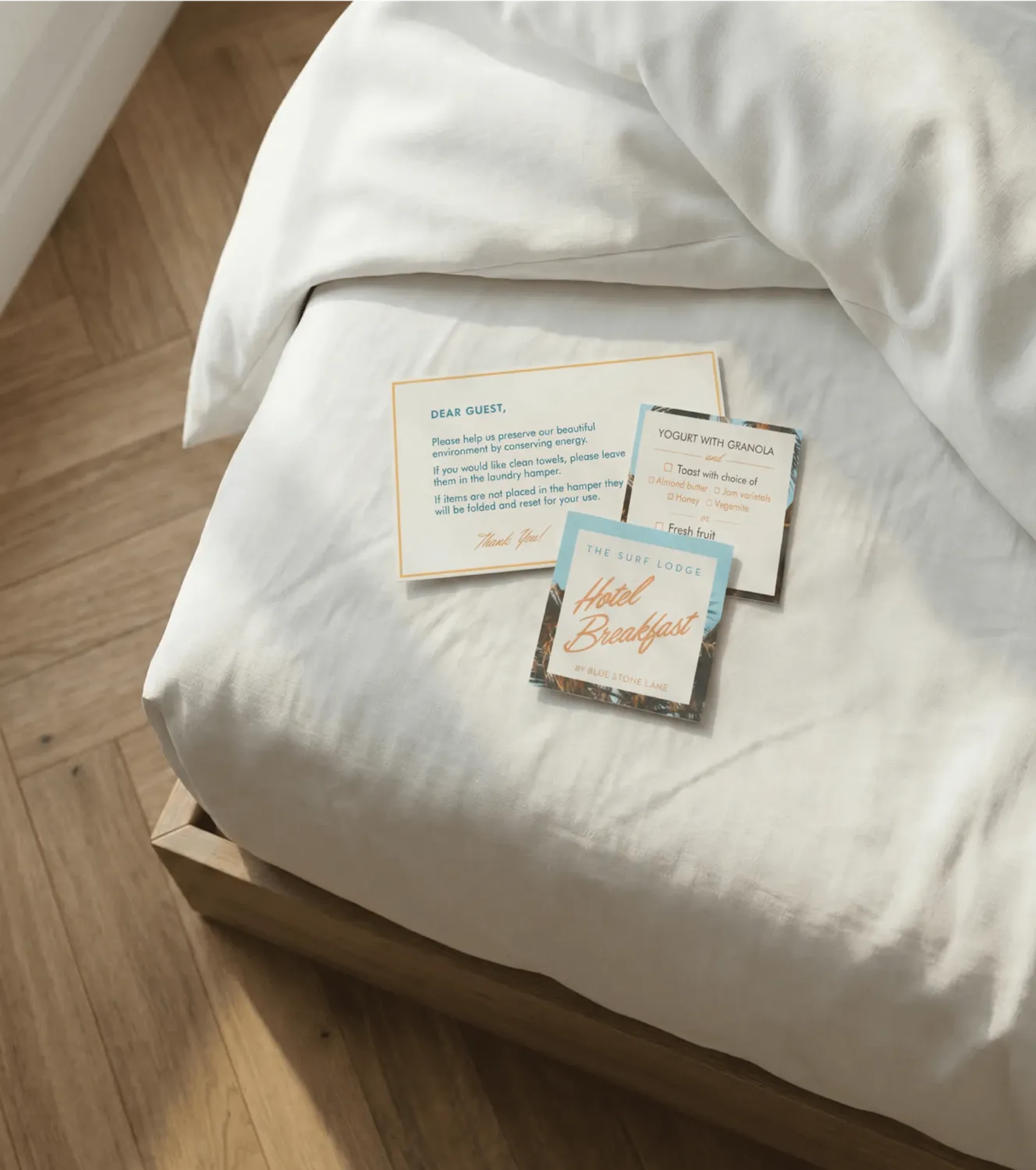 Surf Lodge print materials on a bed.