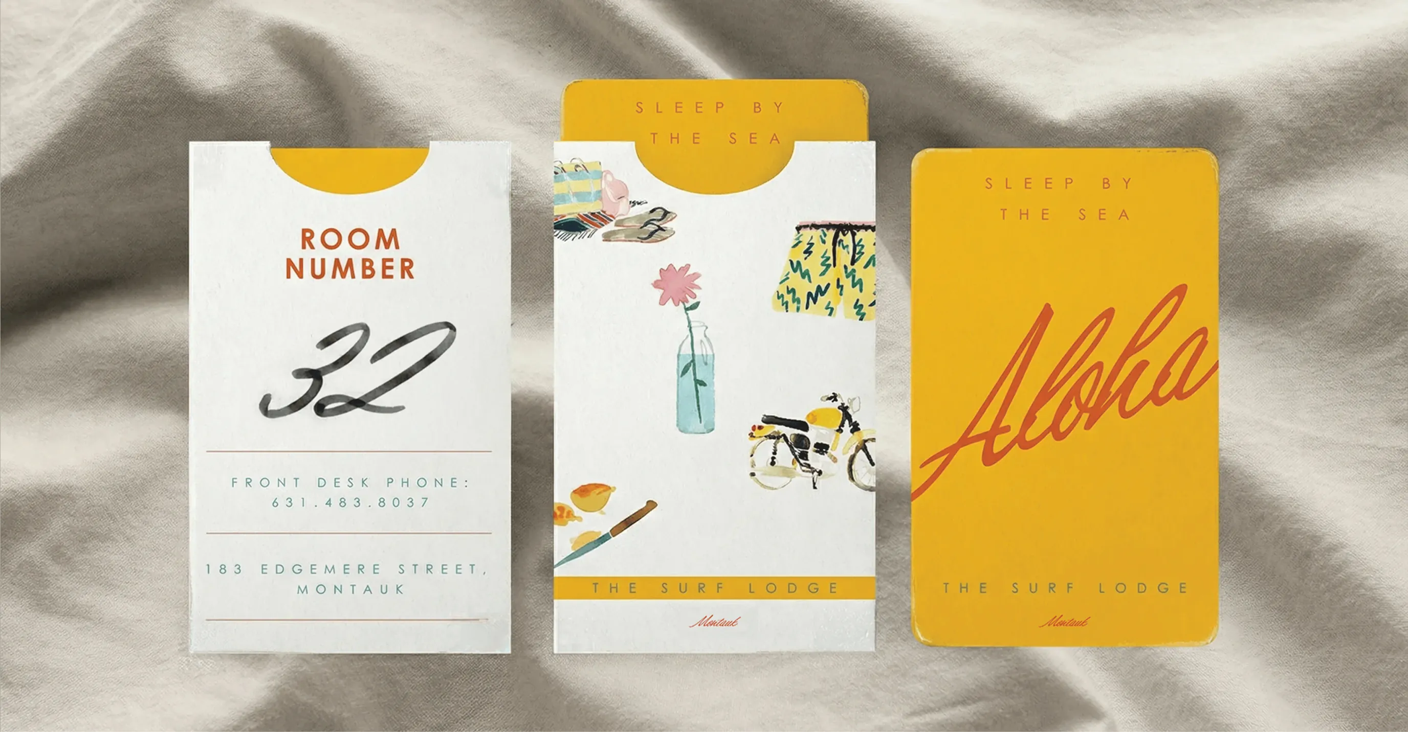 Three hotel key cards with room number and Aloha branding on fabric