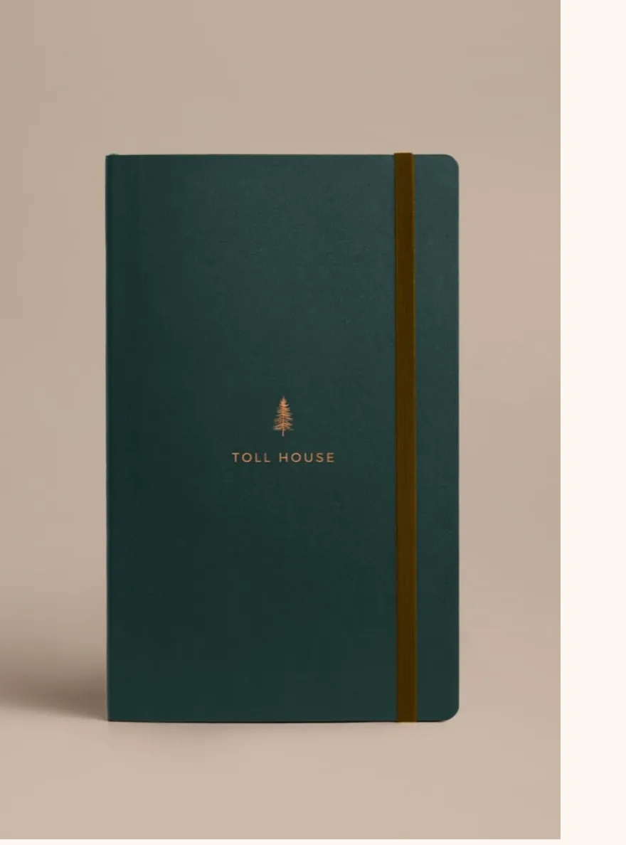Toll House branded notebook with pine tree icon and elastic closure