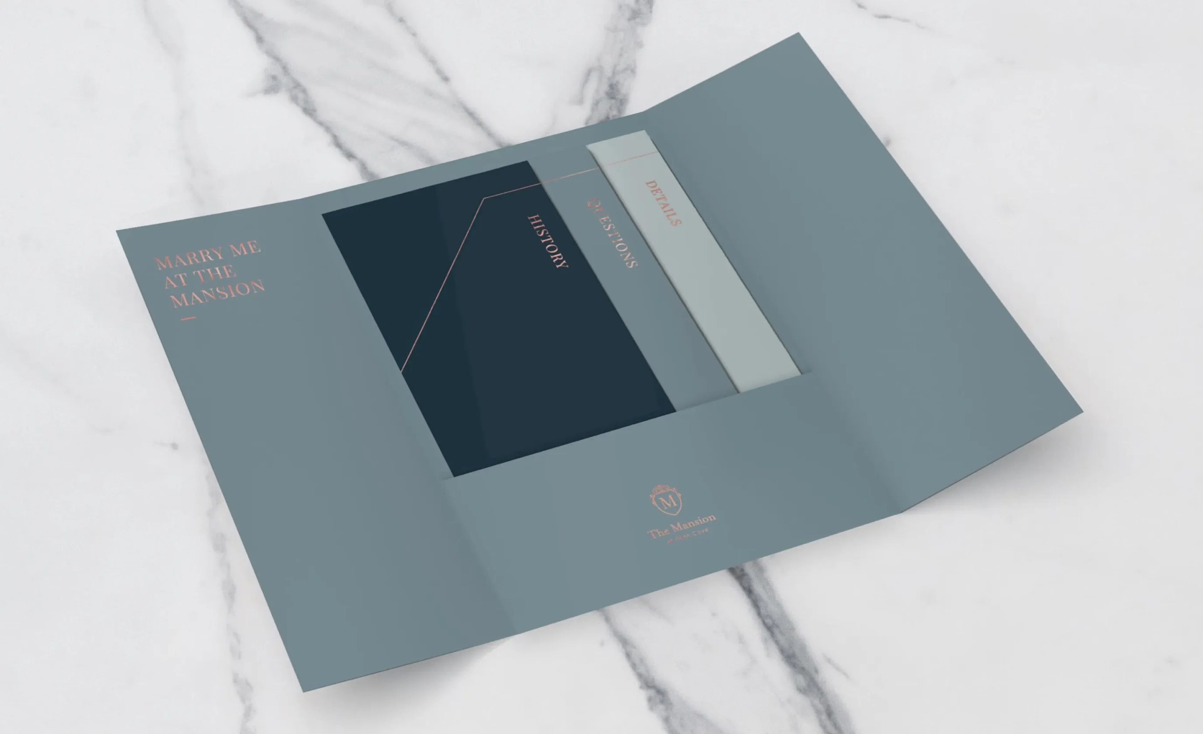 Grey gatefold booklet with embossed logo on marble surface