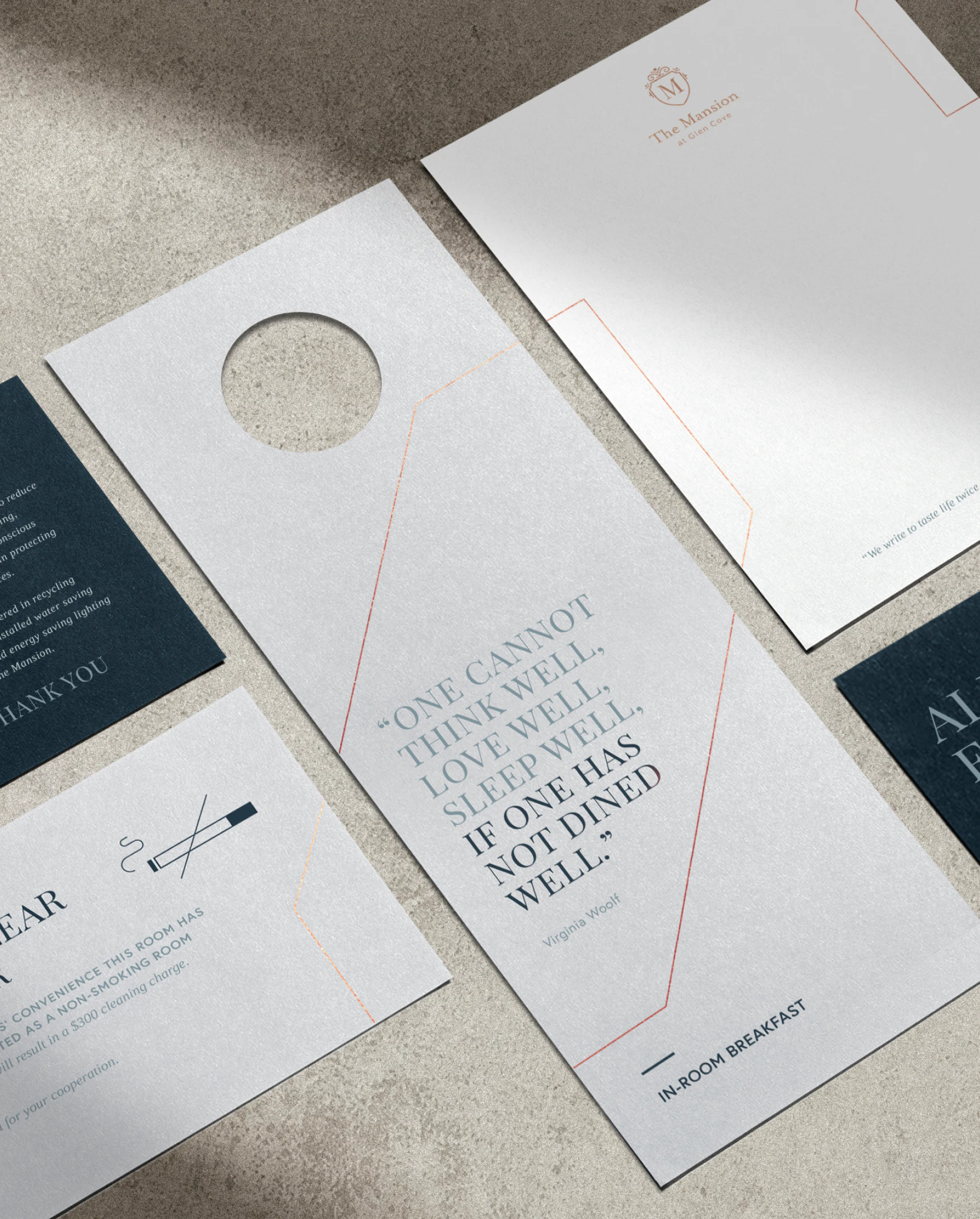 Flat lay perspective of different printed collateral for the Glen Clove Mansion including a door hanger, letterhead and coaster