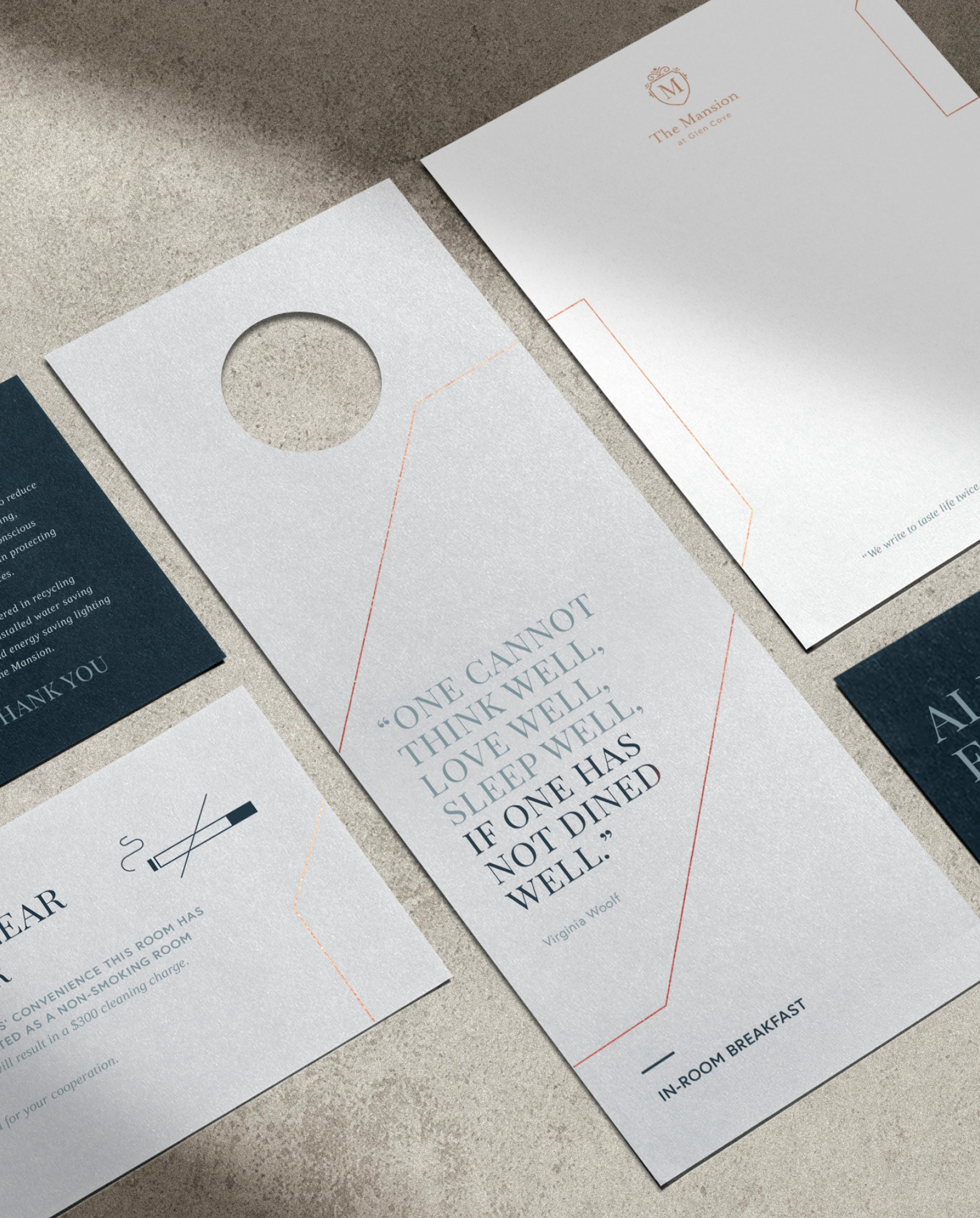 Flat lay perspective of different printed collateral for the Glen Clove Mansion including a door hanger, letterhead and coaster
