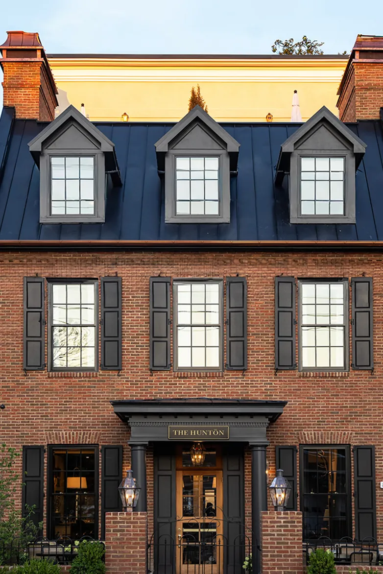 Brick building facade with dormer windows labeled The Hunton