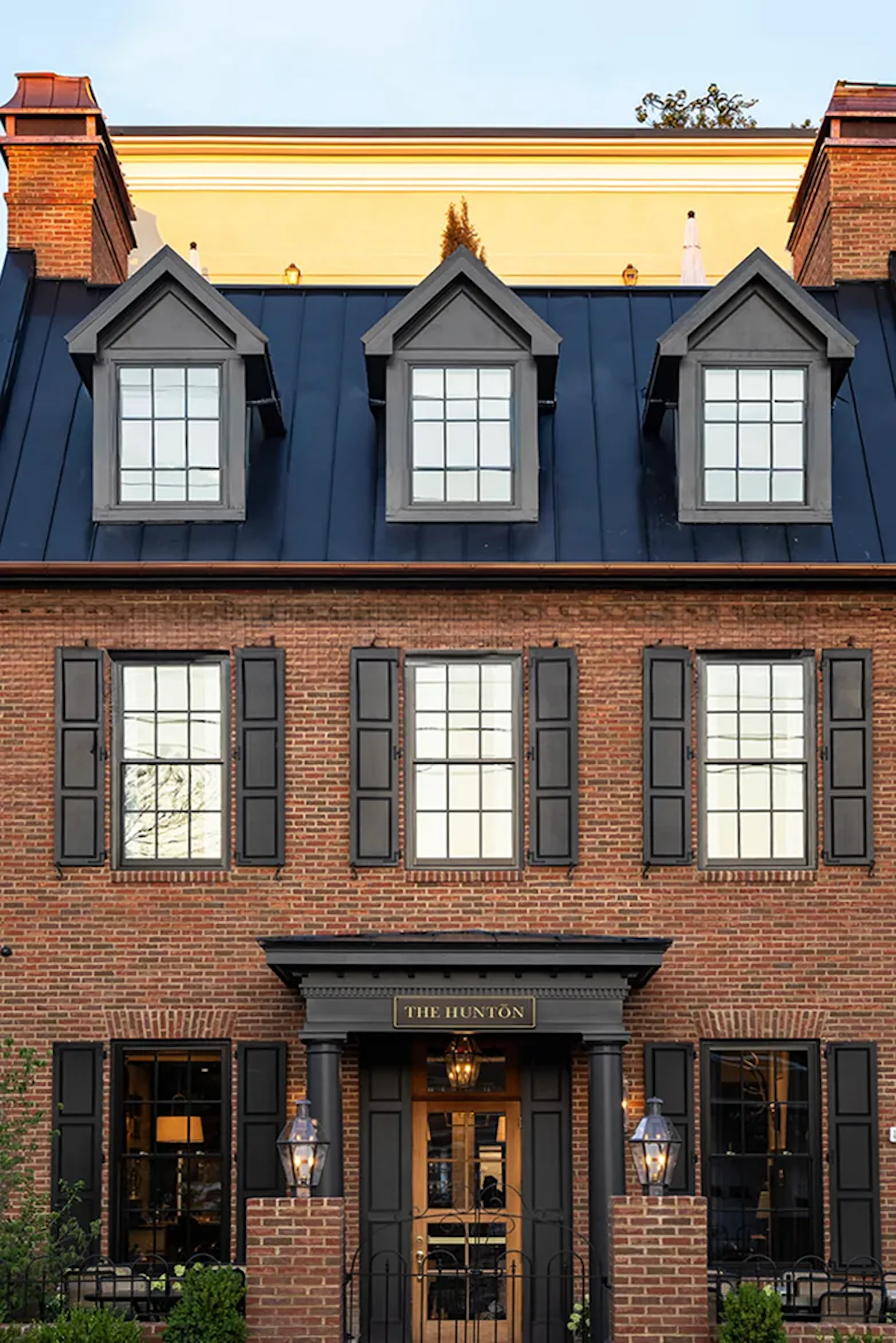 Brick building facade with dormer windows labeled The Hunton