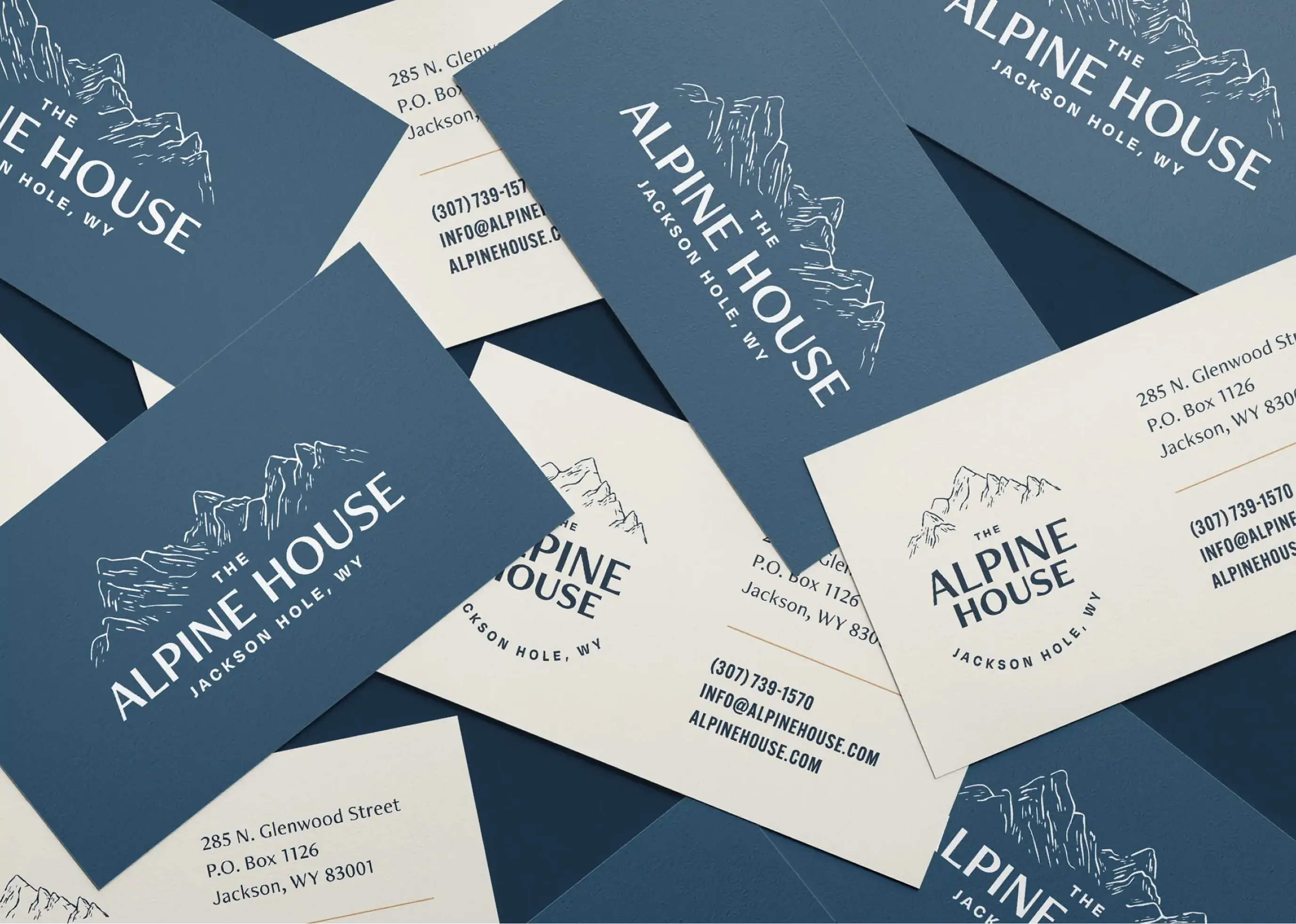 Scattered Alpine House business cards in navy and cream