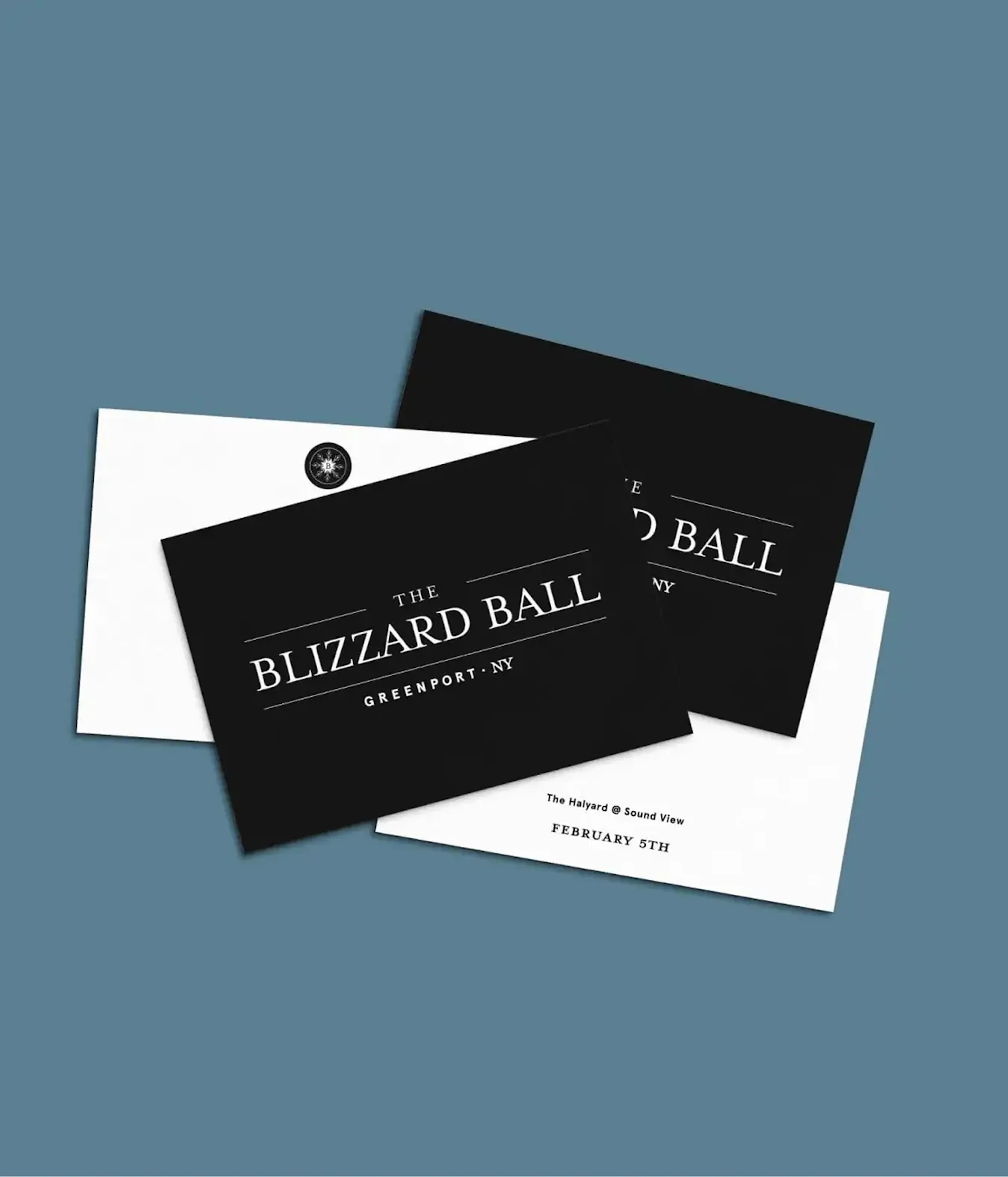 Black and white Blizzard Ball invitation cards on blue background