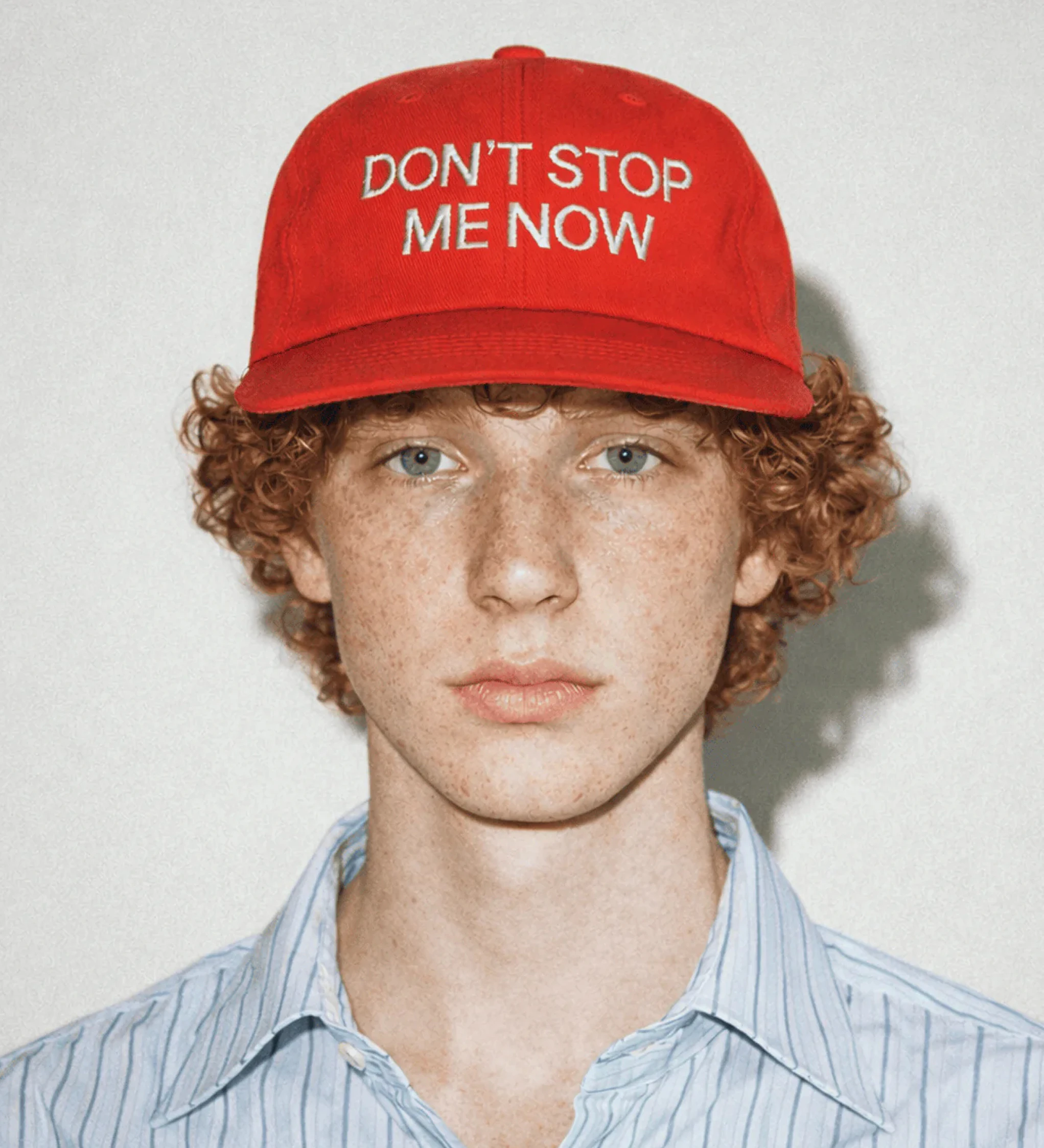 Image of a red hat with "Don't Stop Me Now" on the front.