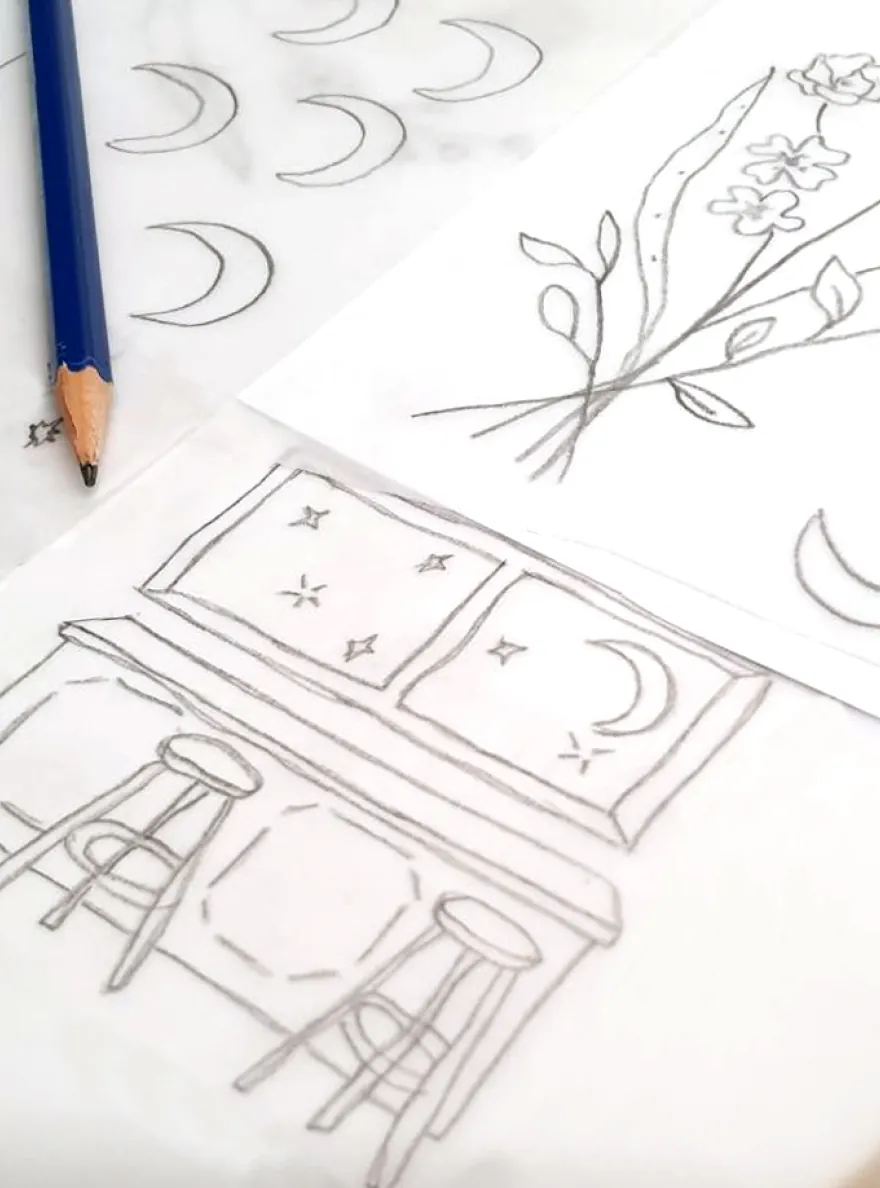 Pencil sketches of florals, moons, and table setting