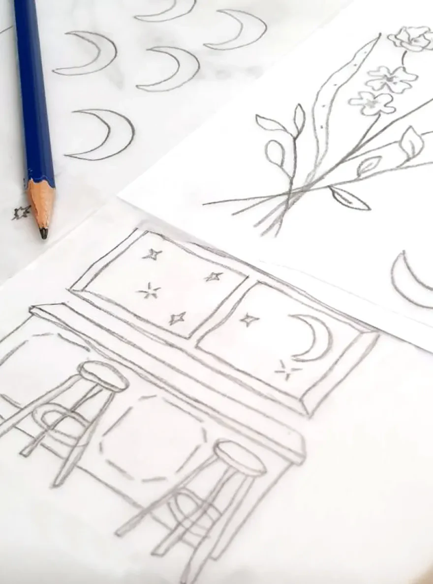 Pencil sketches of florals, moons, and table setting