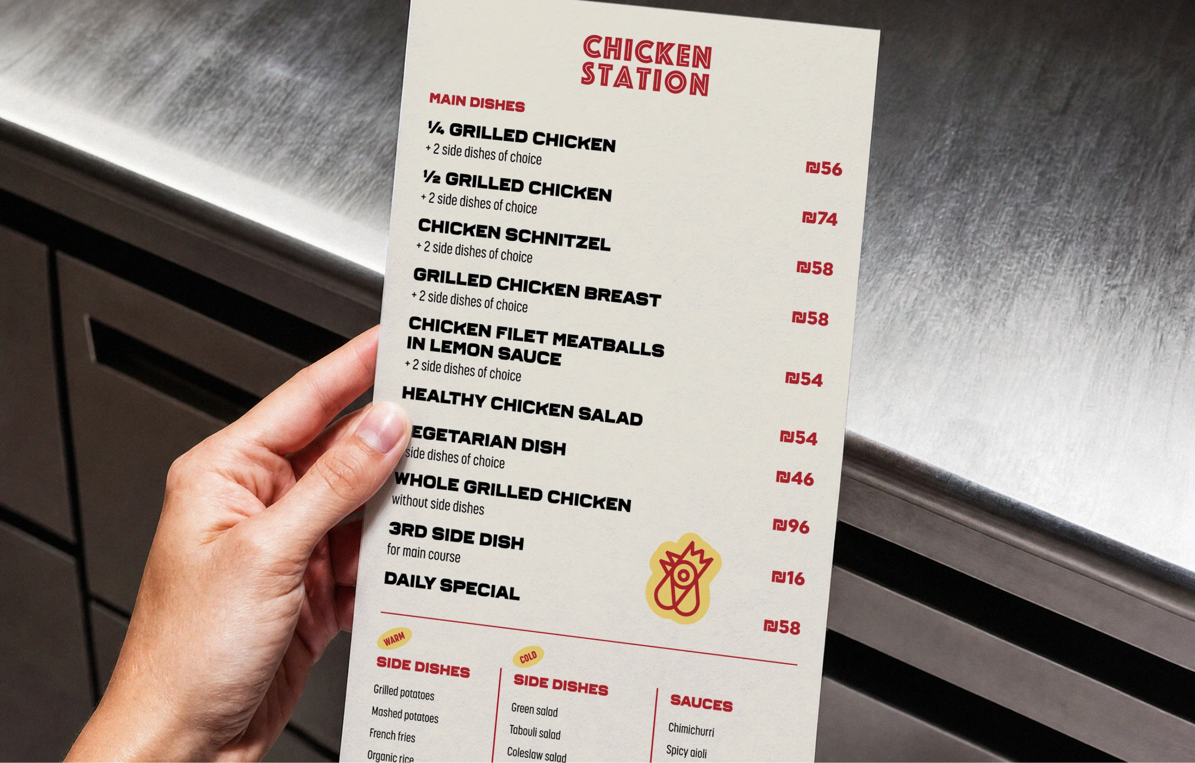 Hand holding a printed Chicken Station menu
