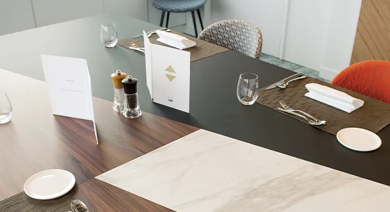 Detail of dining table with different materials: wood, marble and black.