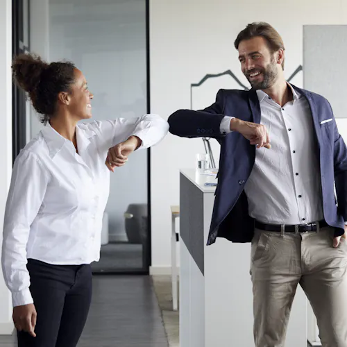 man and woman elbow shake man and woman elbow shake