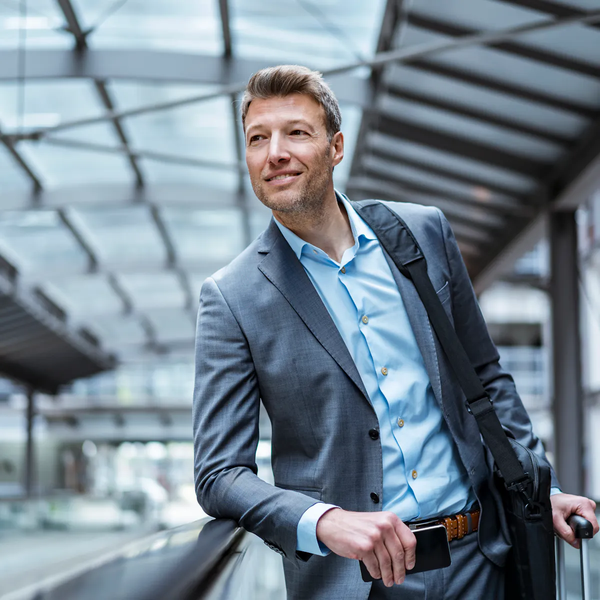 businessman with baggage on moving walkway businessman with baggage on moving walkway