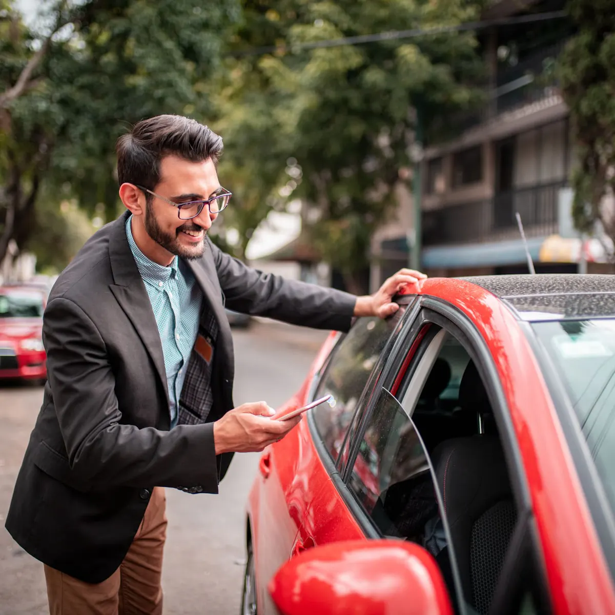 man with red car