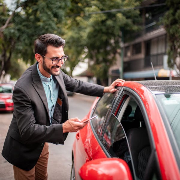 man with red car