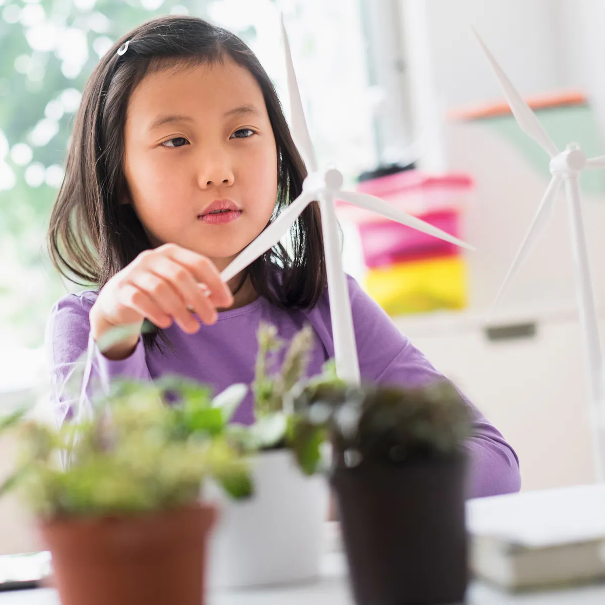 girl play with small wind turbine girl play with small wind turbine