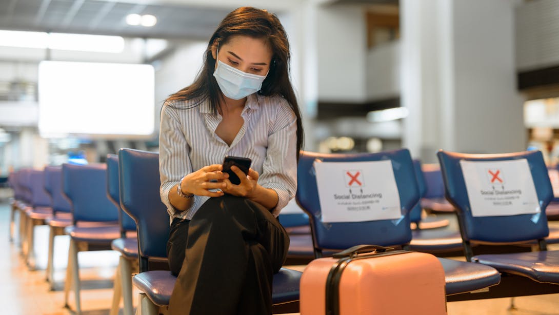 Woman with her phone and baggage Woman with her phone and baggage