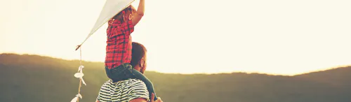 man with his daughter on his shoulders man with his daughter on his shoulders